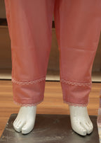 Pink satin pants with lace trim worn by a mannequin on a wooden floor.