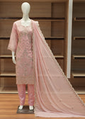 Mannequin wearing a pink embroidered outfit with a matching dupatta on a wooden floor.