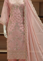 Pink embroidered traditional outfit with a dupatta on a mannequin against a neutral background