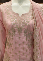 Pink embroidered traditional outfit on a mannequin
