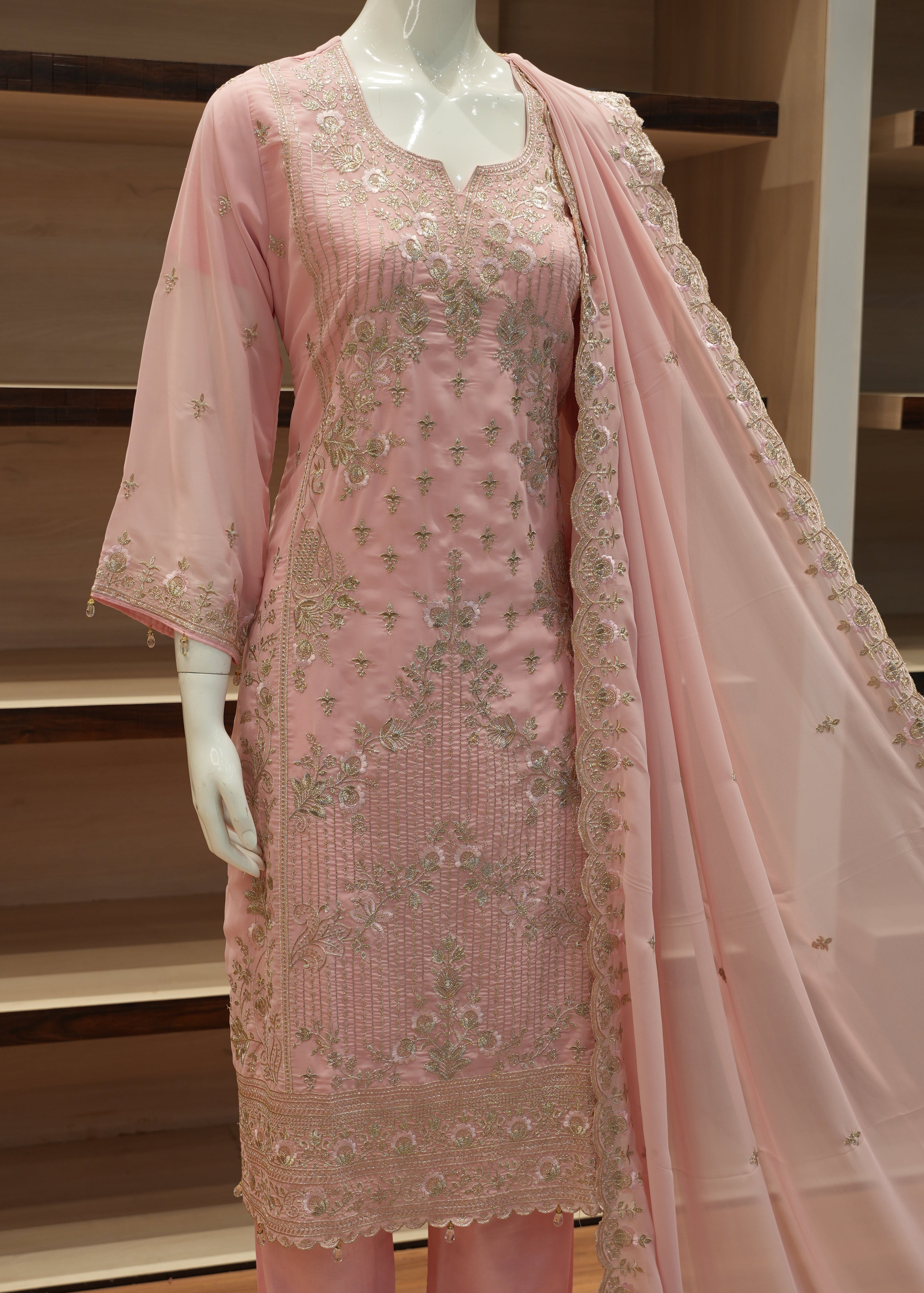 Pink fabric with floral patterns on a mannequin against a neutral background