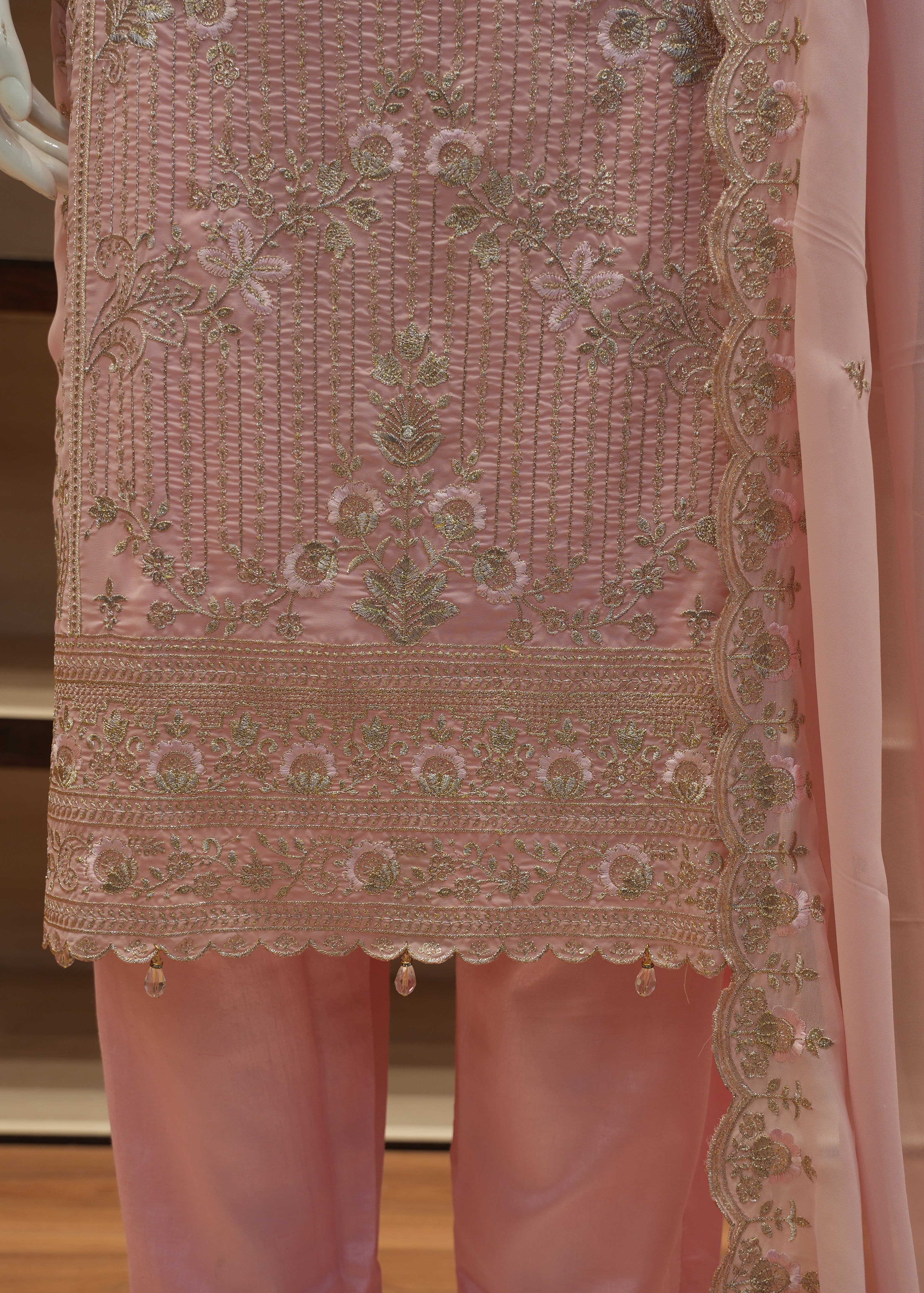 Pink embroidered traditional outfit with a sheer dupatta.