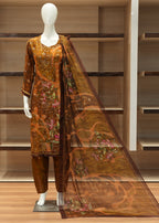 Mannequin wearing a brown floral outfit with a matching dupatta in a store setting.