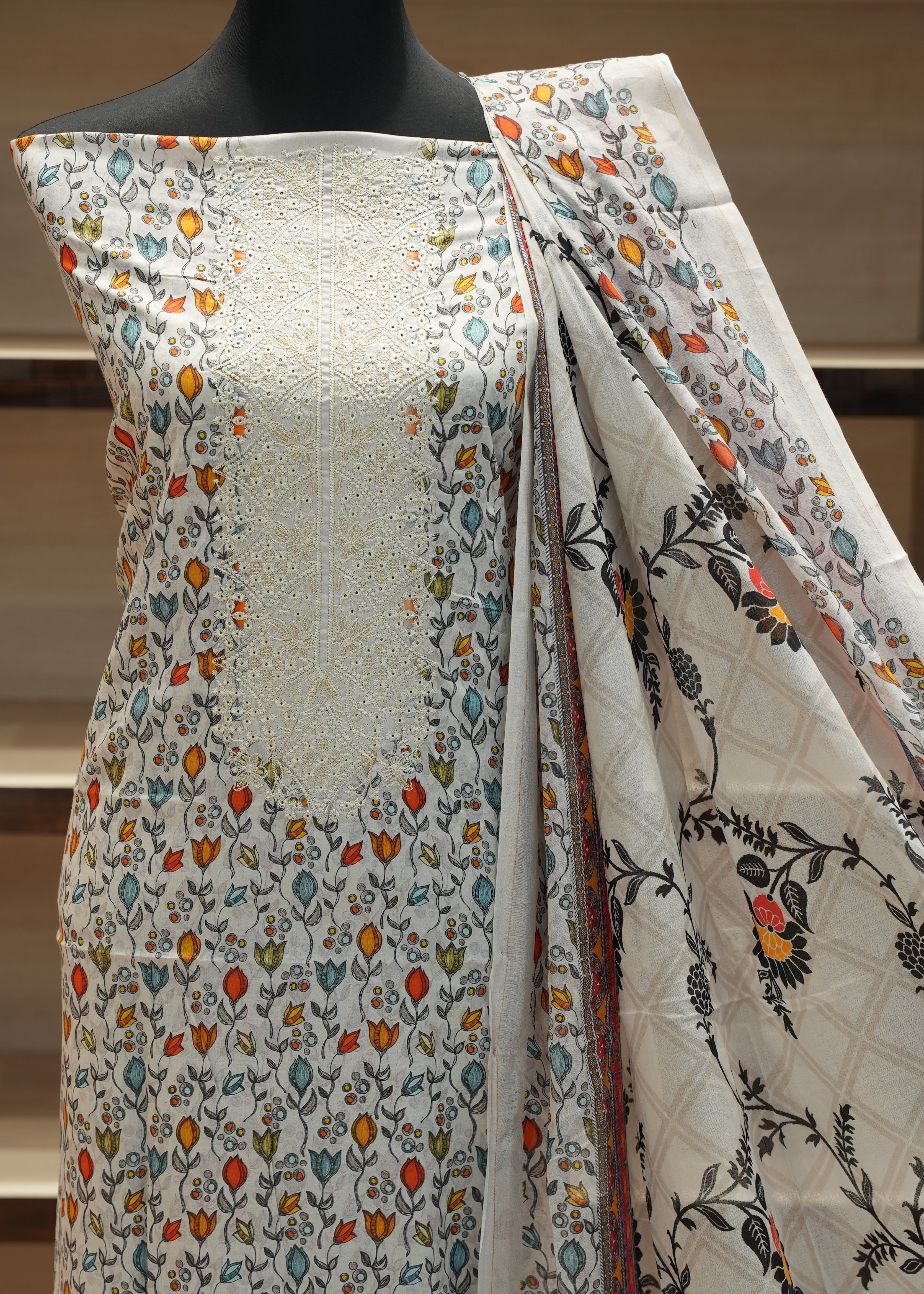 Floral patterned fabric draped over a mannequin against a neutral background