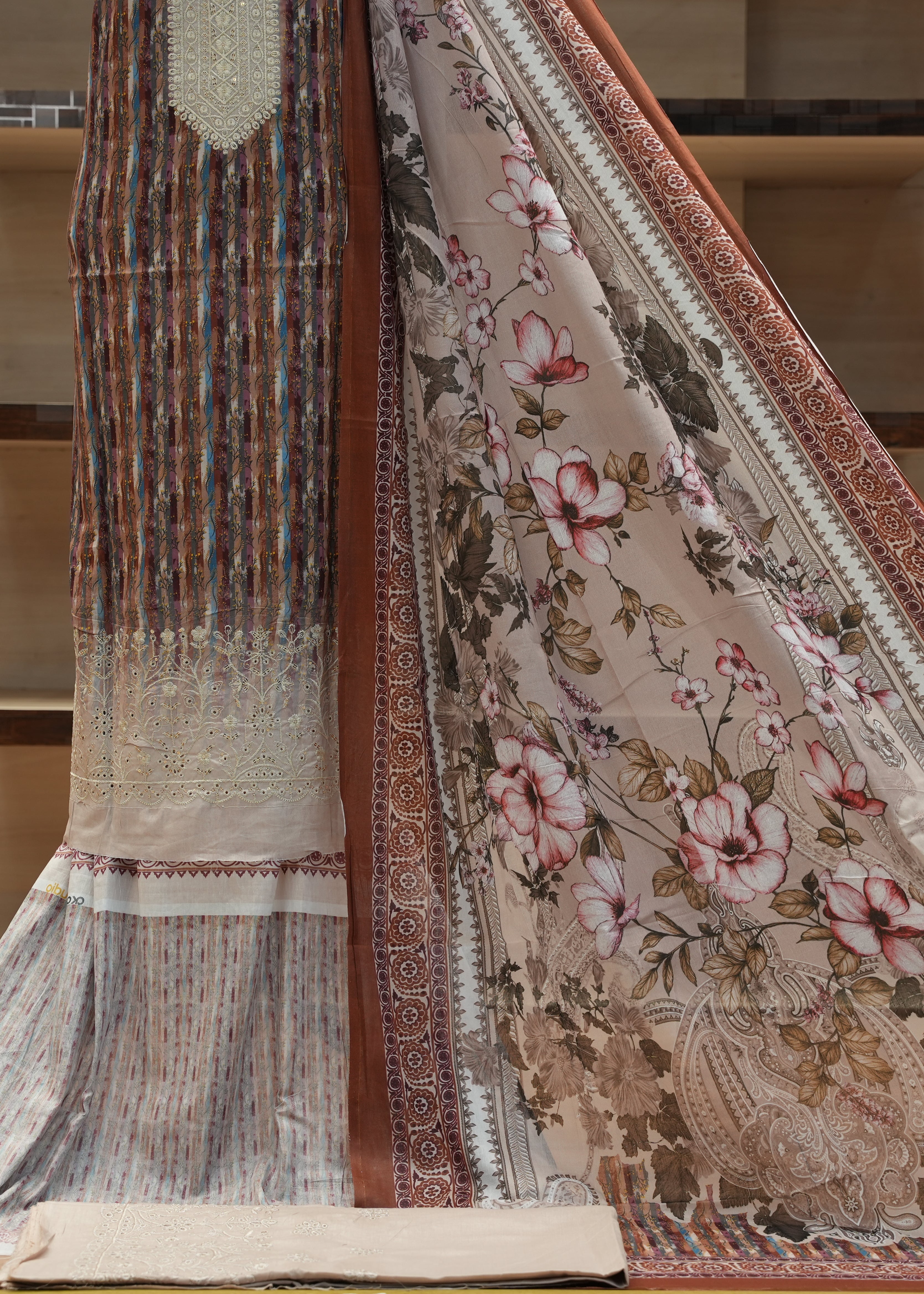 Two patterned rugs displayed side by side on a wooden floor.