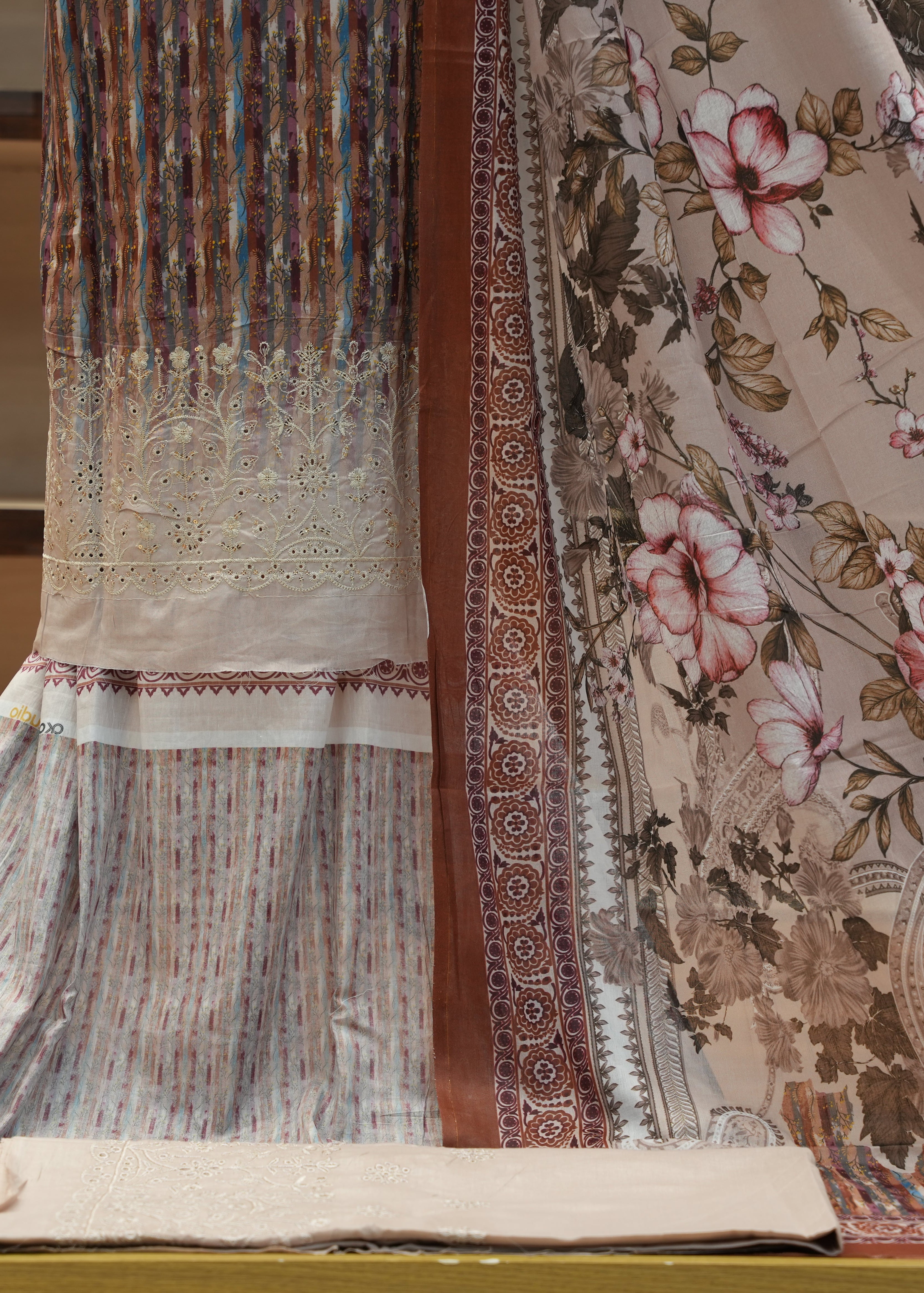 Floral patterned fabric with intricate designs on a plain background