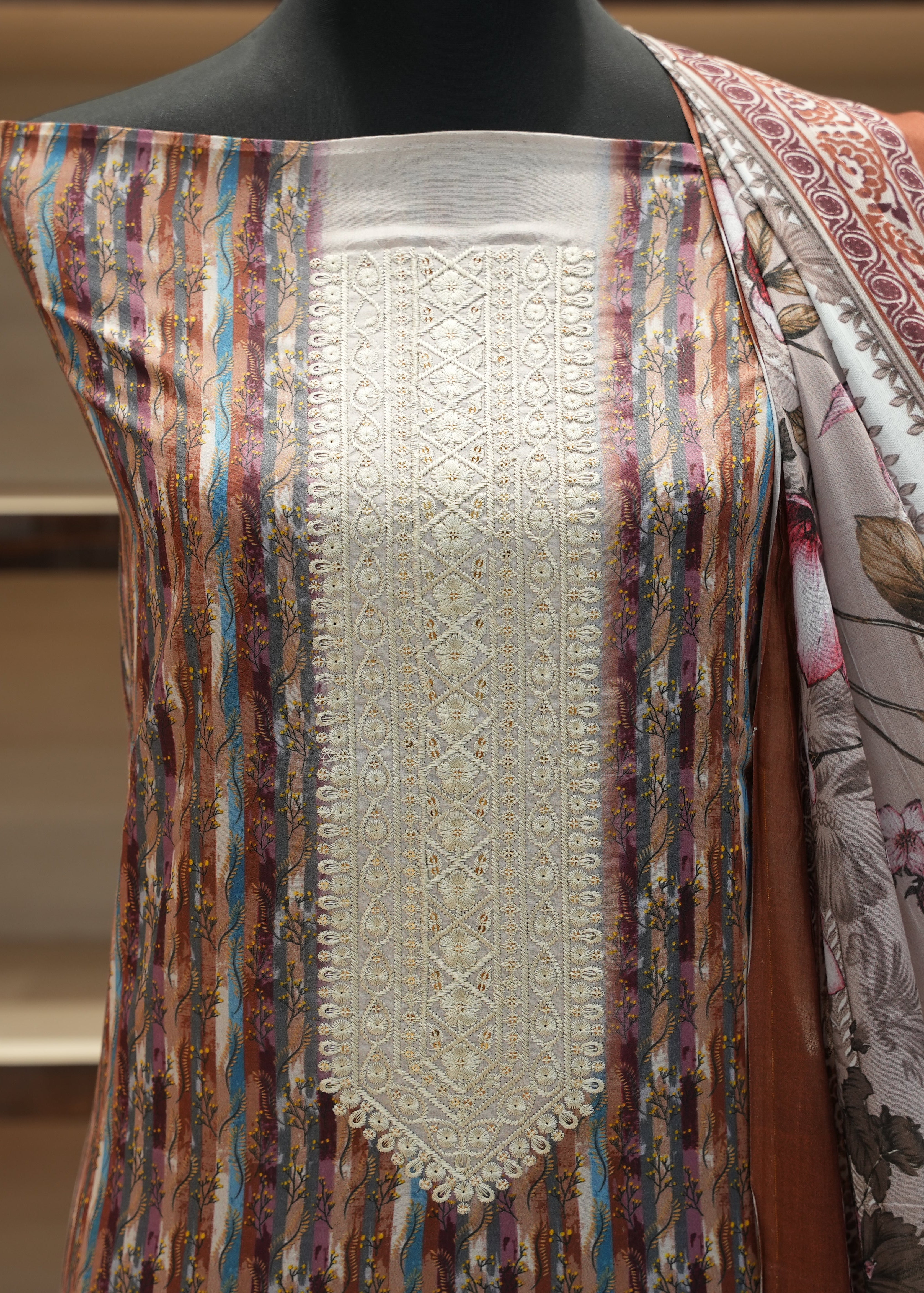 Mannequin wearing a colorful scarf with intricate patterns