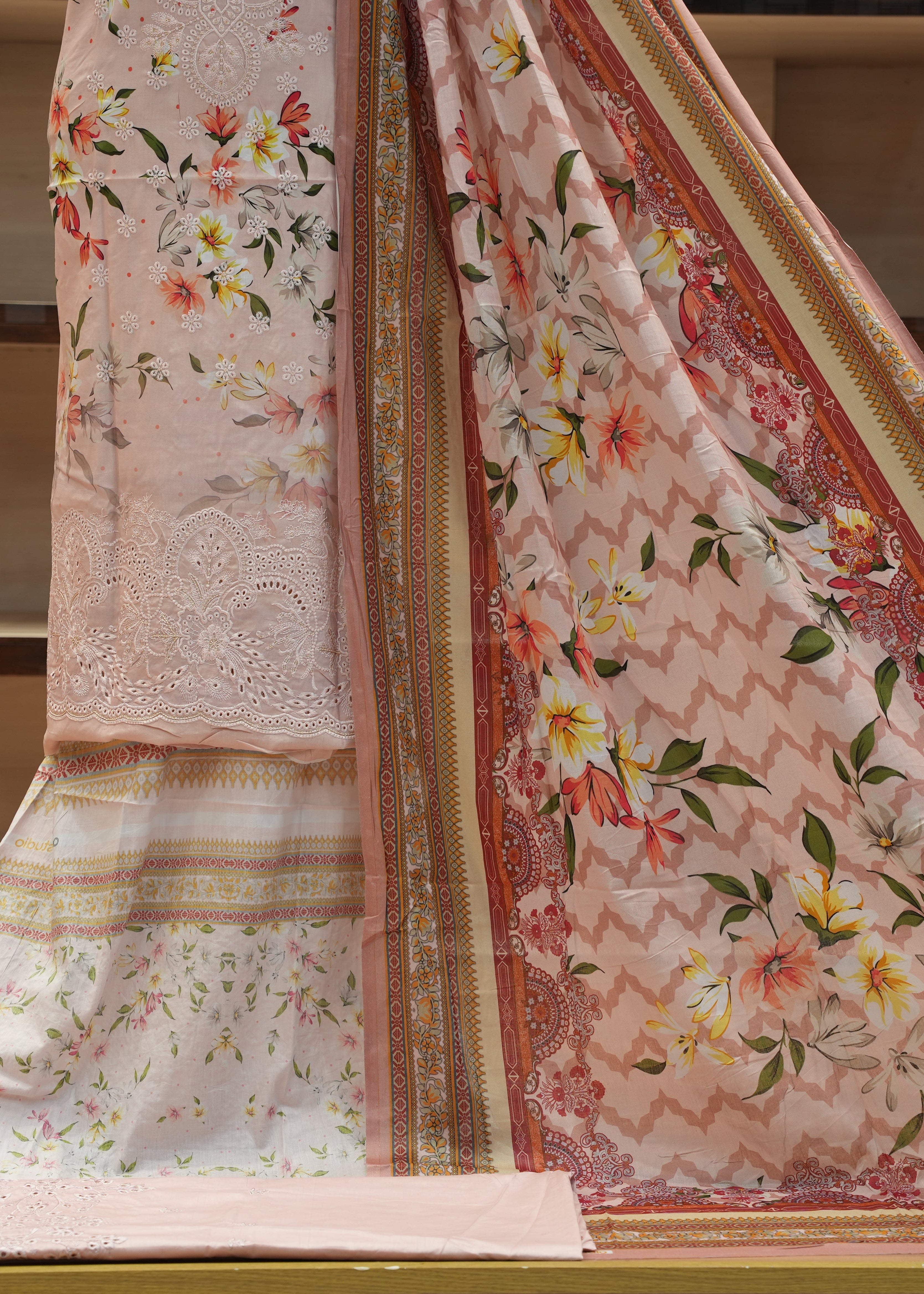 Floral patterned fabric with intricate designs on a neutral background