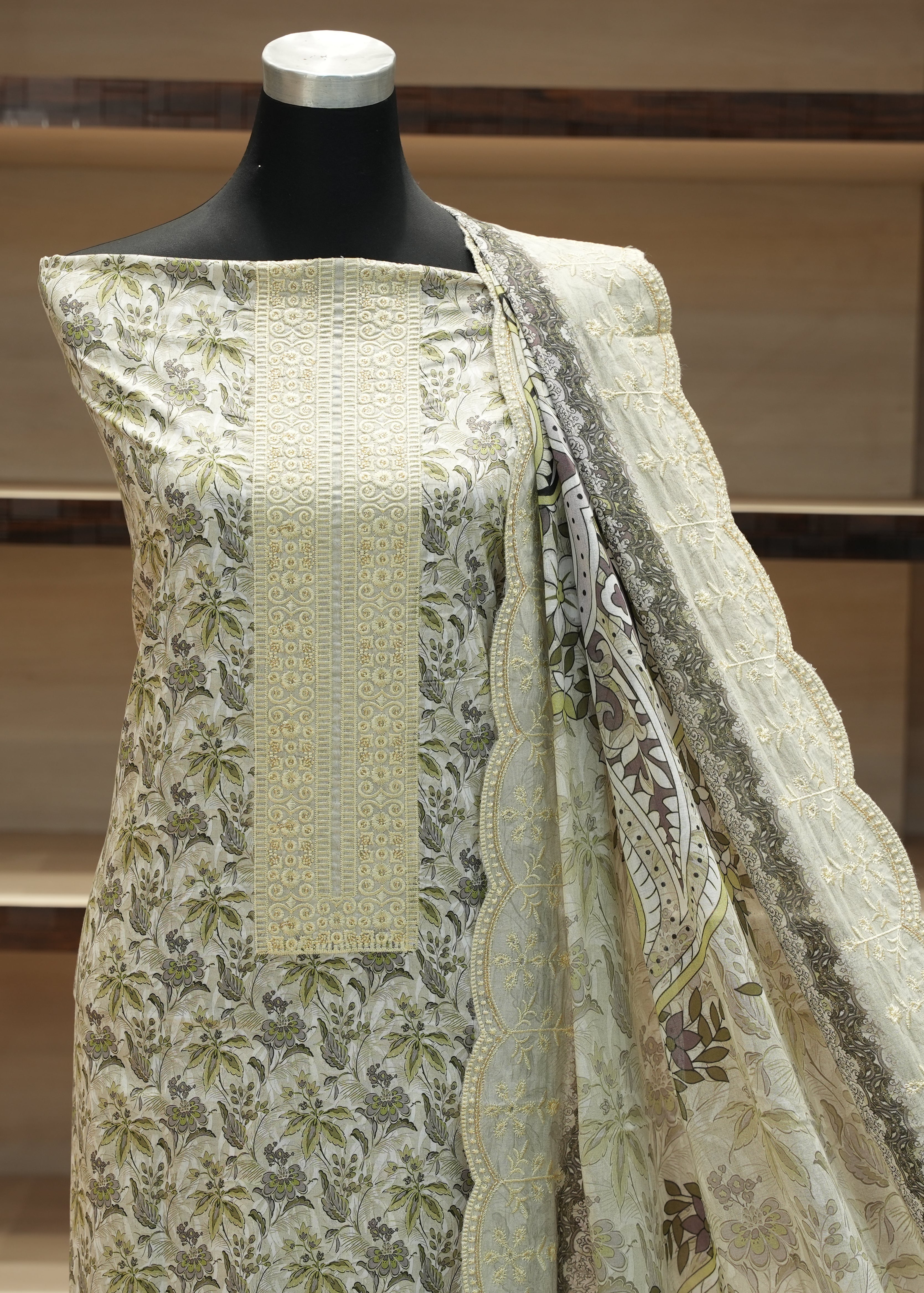 Mannequin wearing a traditional outfit with floral patterns in a neutral setting
