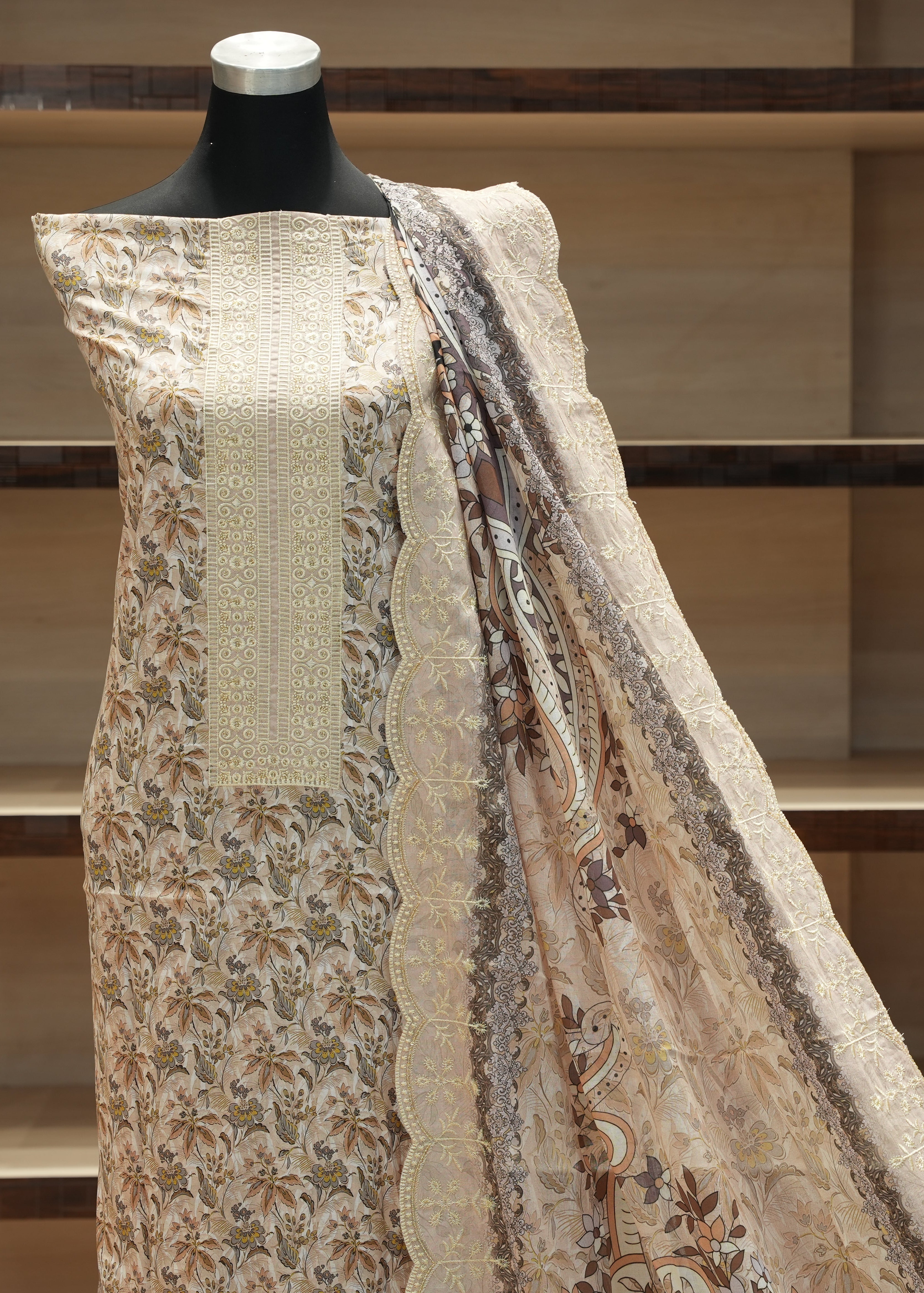 Mannequin wearing a floral patterned outfit with a plain background