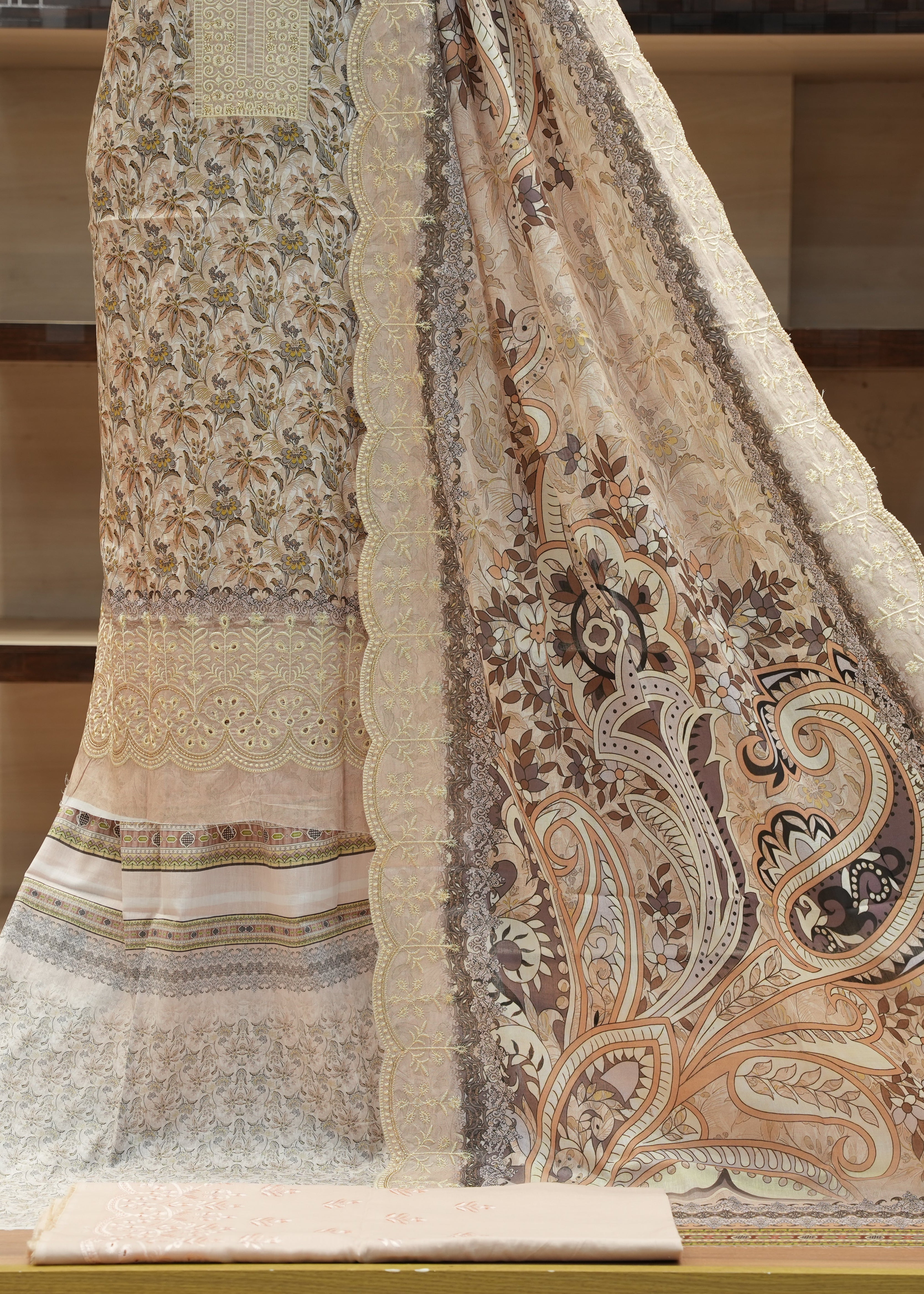 Delicate lace fabric with intricate patterns on a wooden surface
