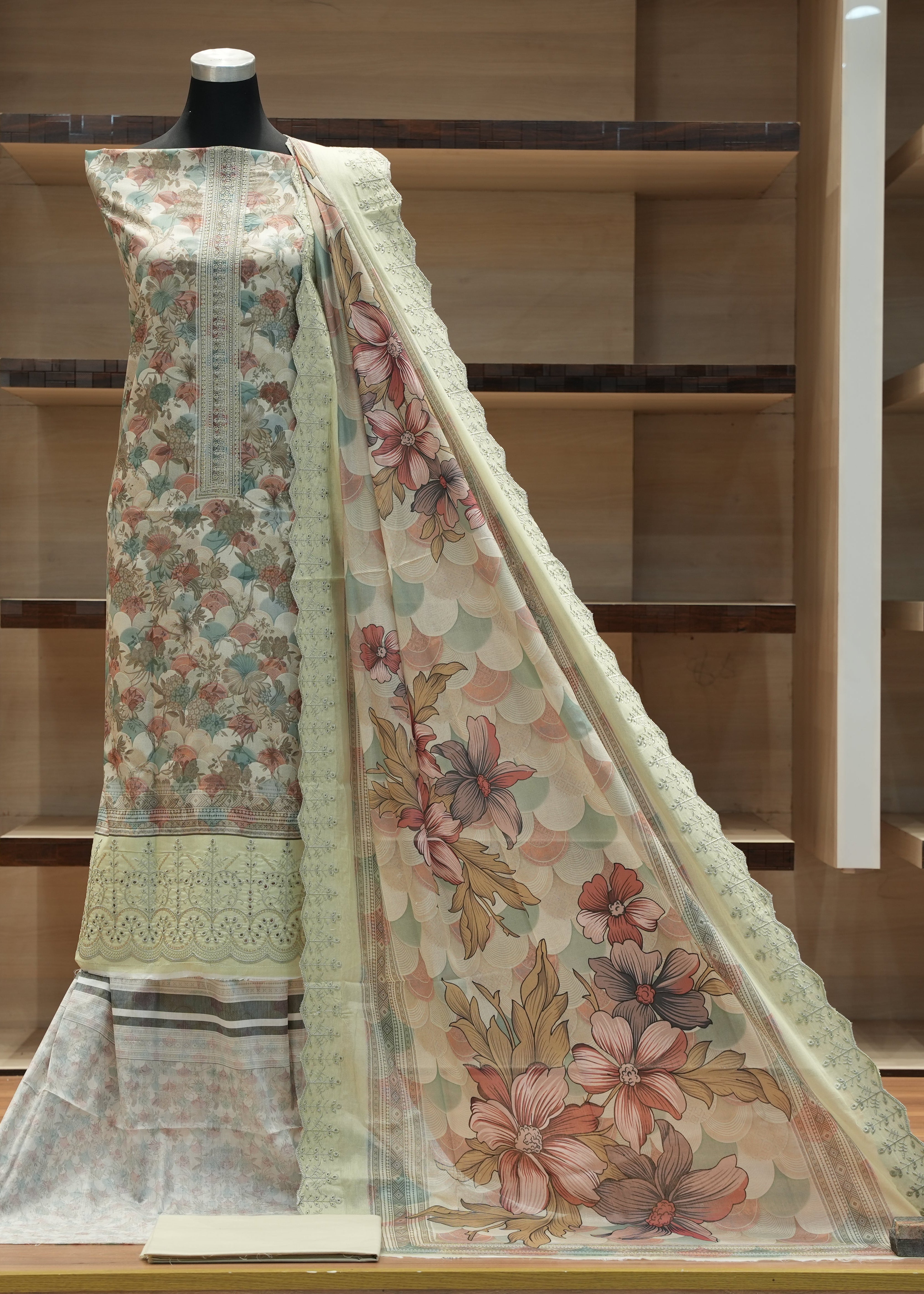 Floral dress with dupatta on a mannequin against a wooden background