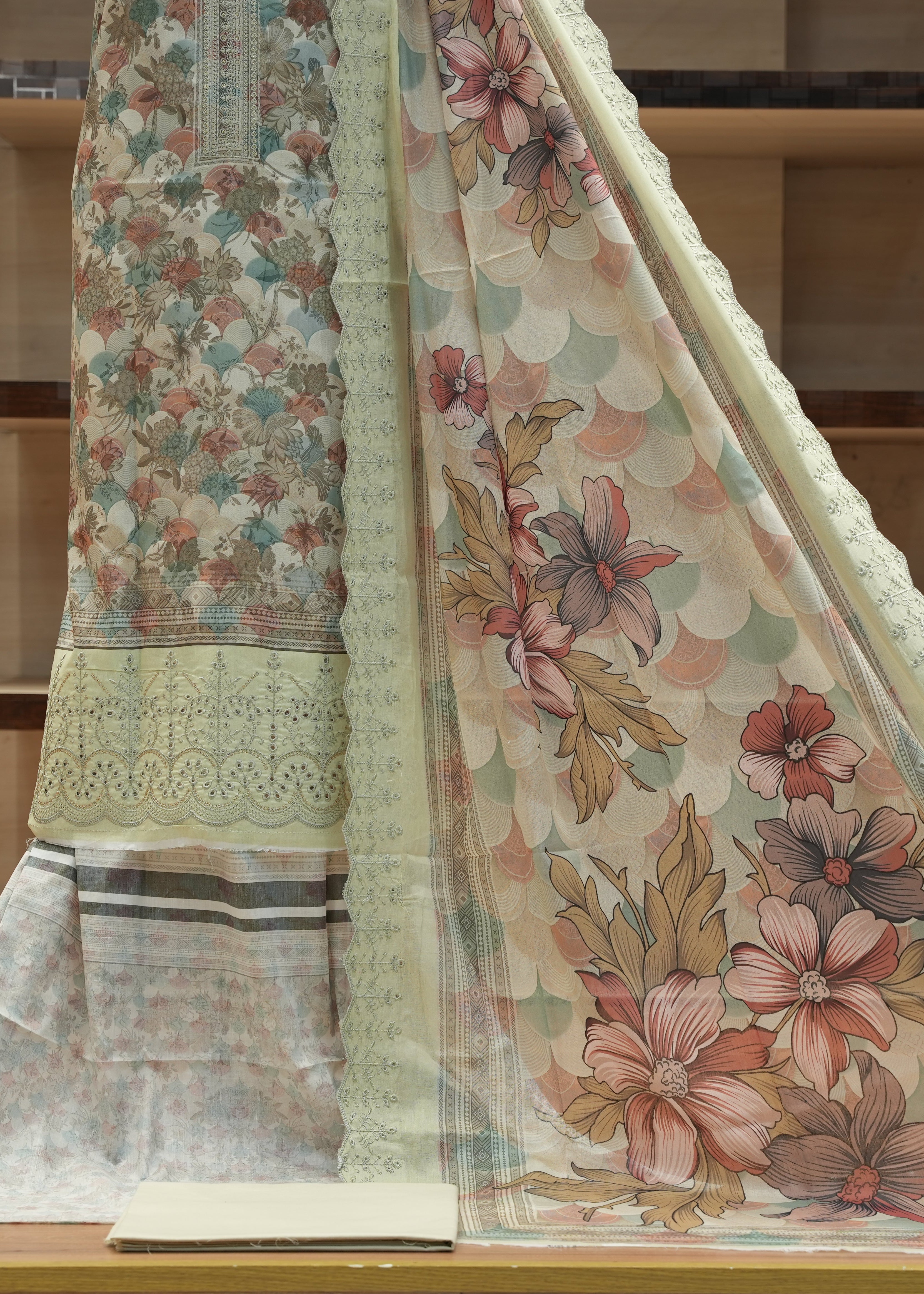 Floral patterned fabric on a wooden surface with a neutral background