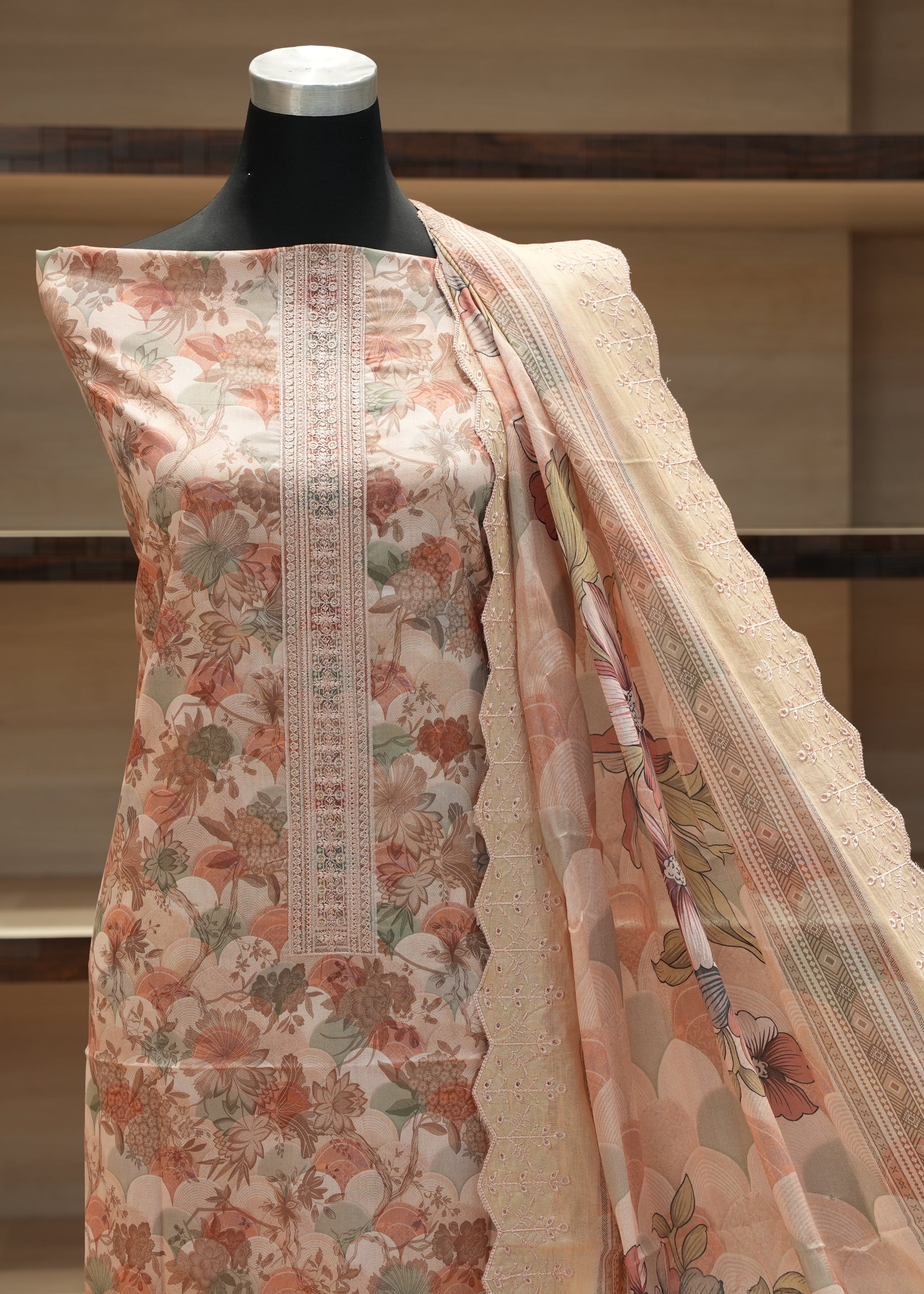 Floral patterned dress on a mannequin with a neutral background