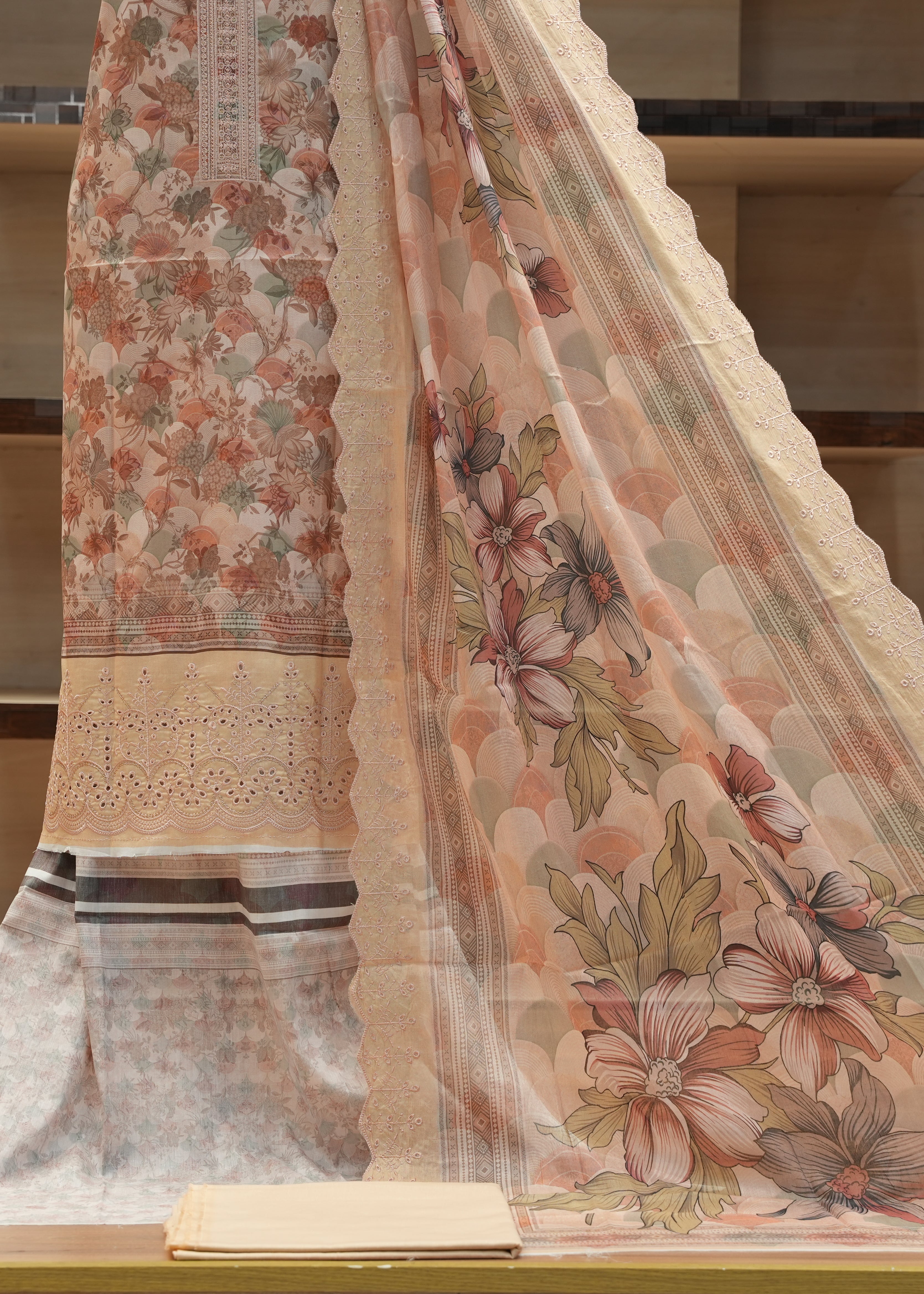 Floral patterned fabric draped over a surface with a neutral background
