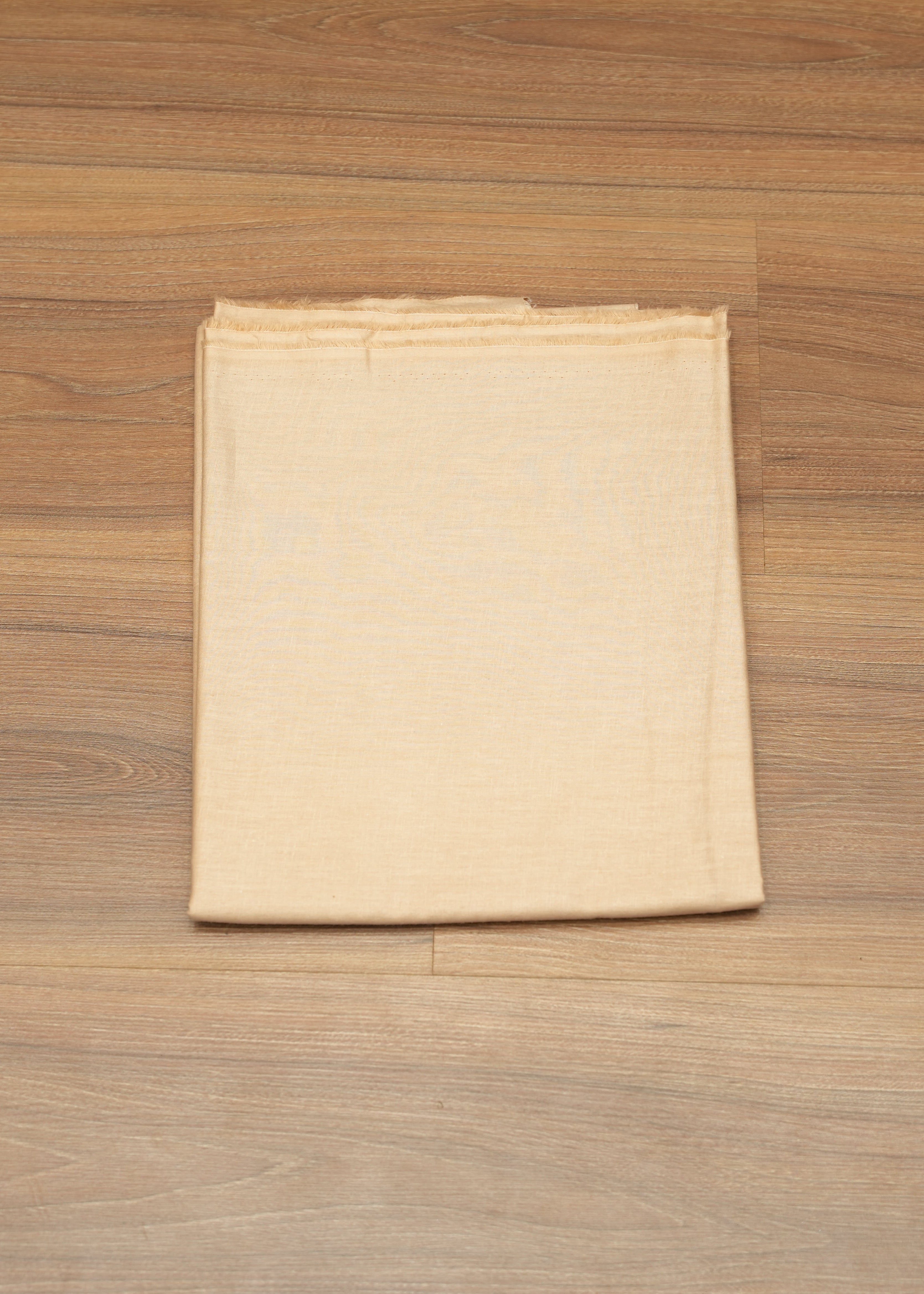 Beige fabric on a wooden surface