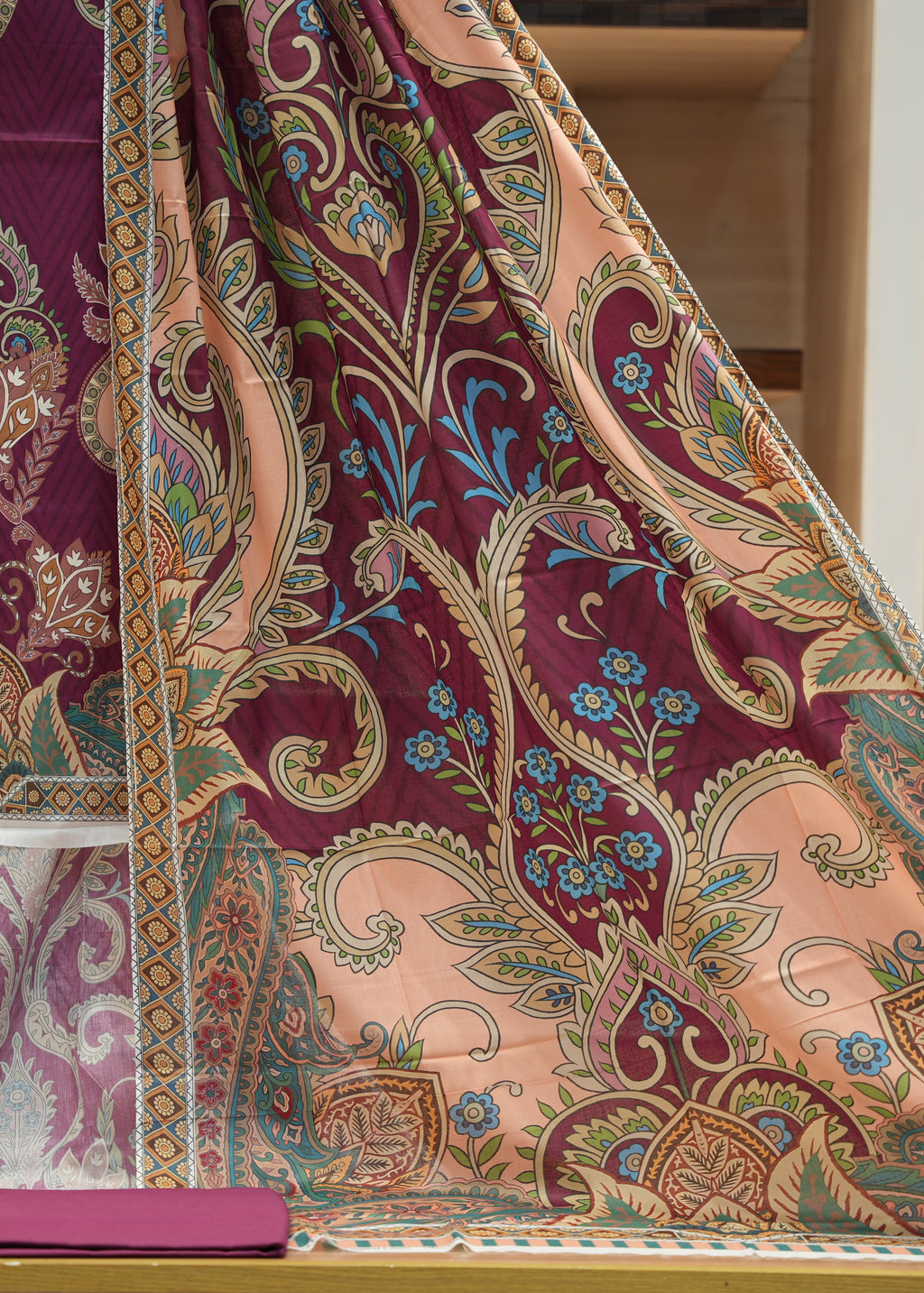 Patterned fabric with intricate designs on a wooden surface