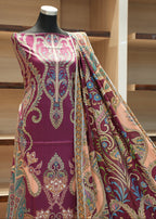 Mannequin wearing a piece of patterned fabric with a wooden shelf background