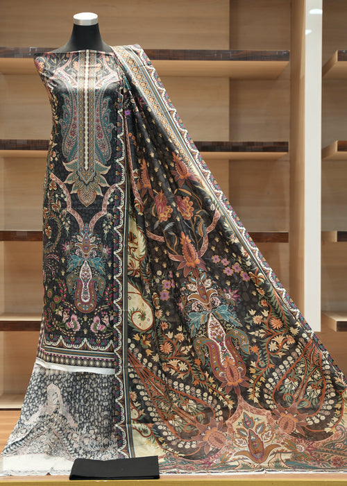 Decorative fabric with intricate patterns on a mannequin against a wooden background