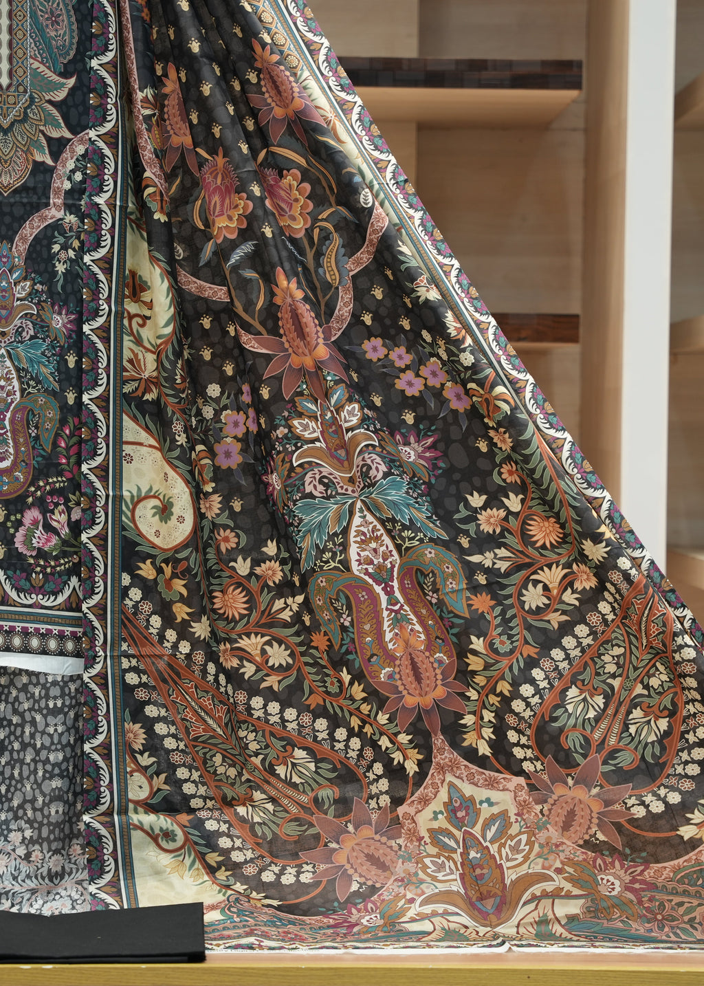 Decorative fabric with intricate patterns on a wooden surface