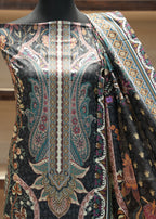 Mannequin wearing a black fabric with intricate paisley patterns in various colors.