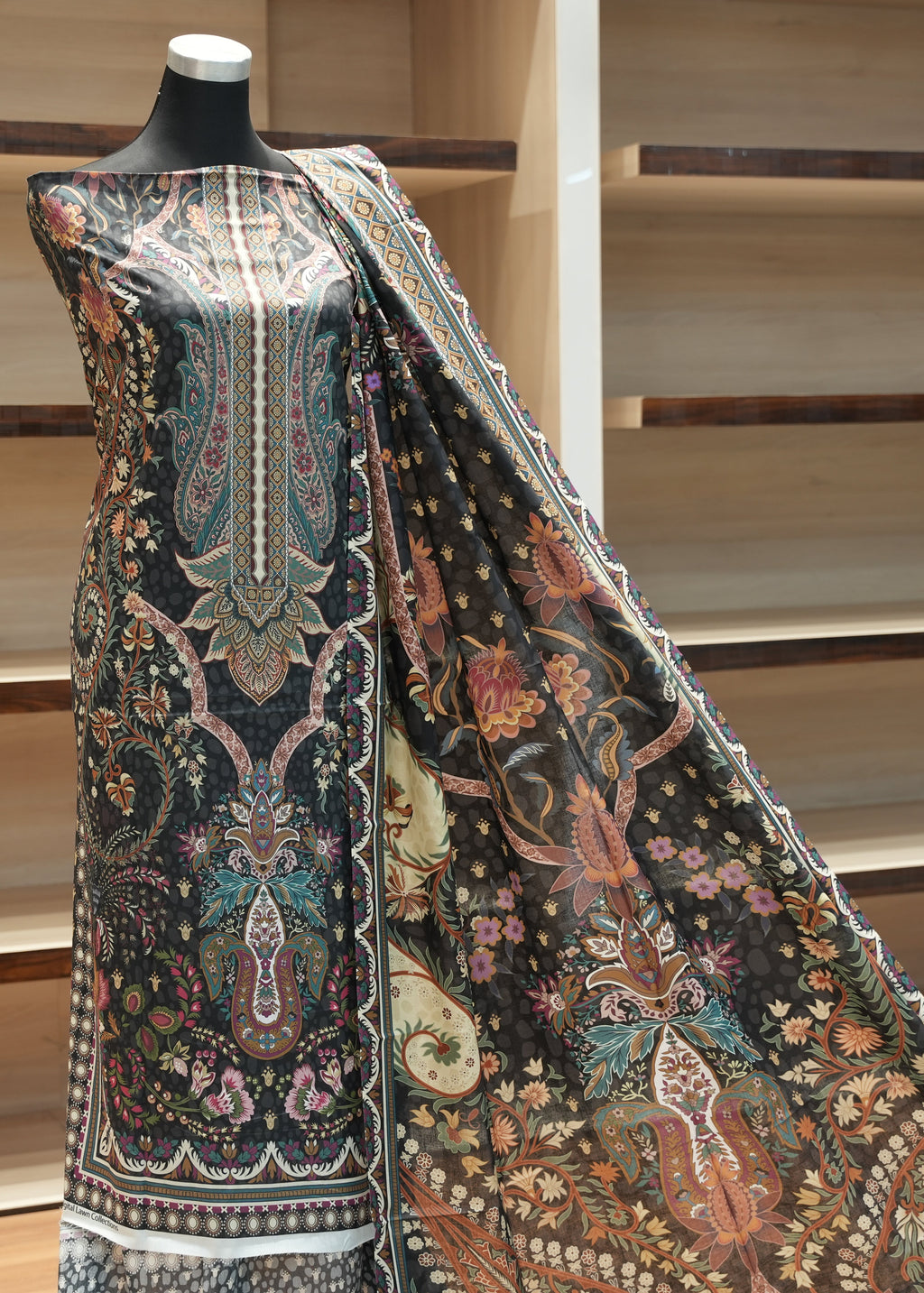 Mannequin wearing a patterned fabric with a wooden background