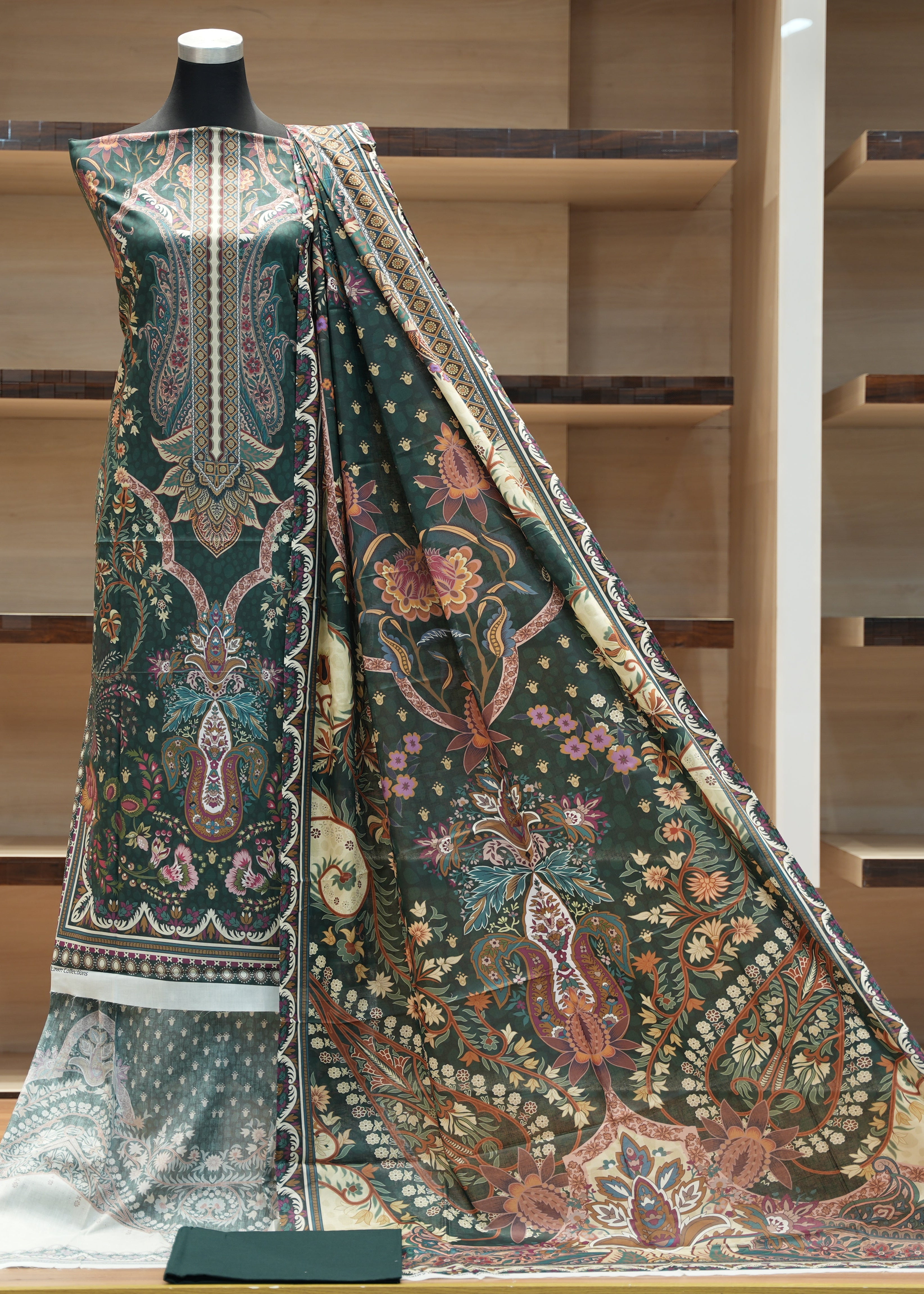 Traditional embroidered garment on a mannequin against a wooden shelf background