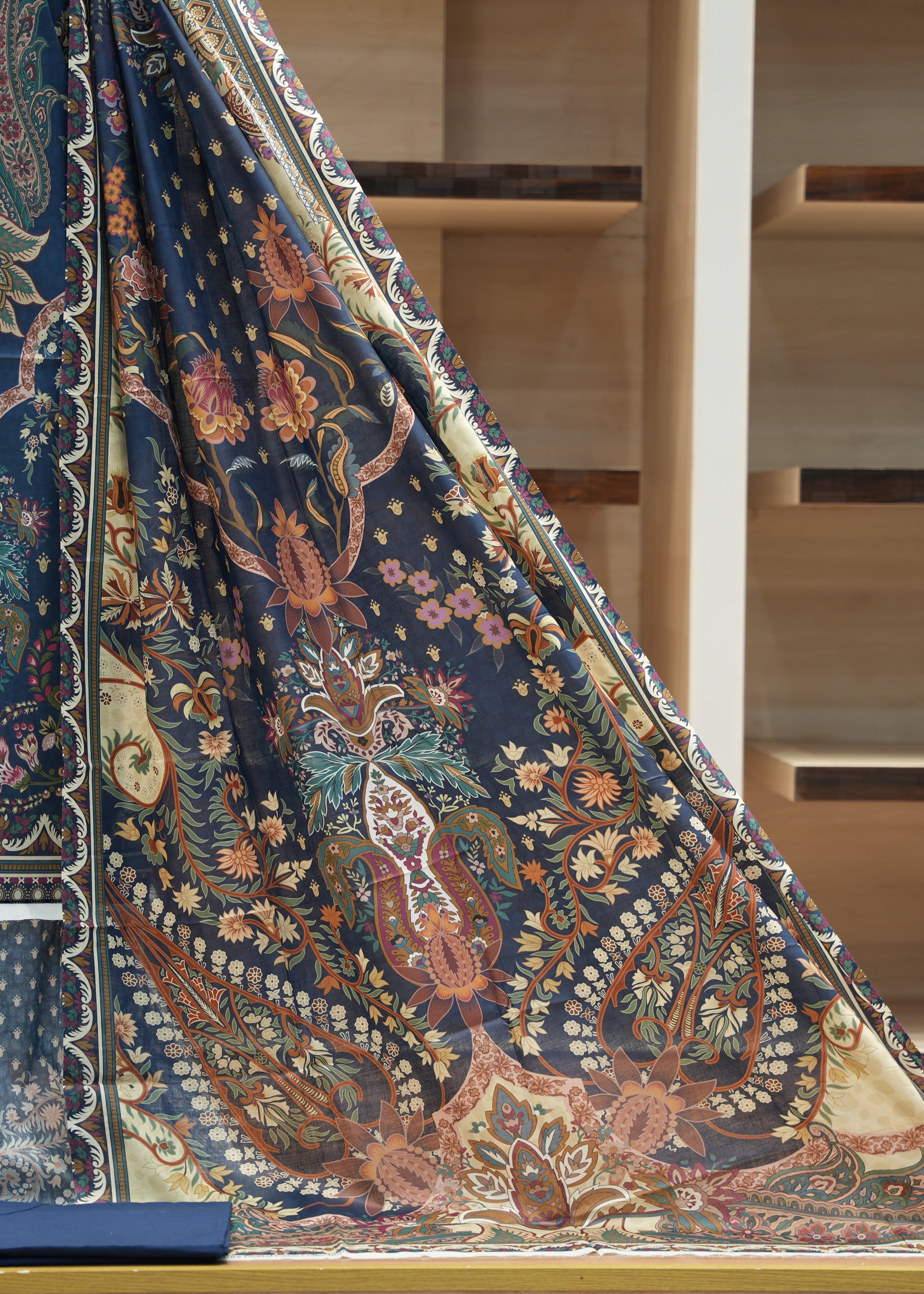 Decorative fabric with intricate patterns draped over a staircase.