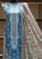 Mannequin wearing a colorful traditional garment with intricate patterns.
