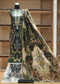 Mannequin wearing a patterned dress with a large scarf draped over it in a store setting.