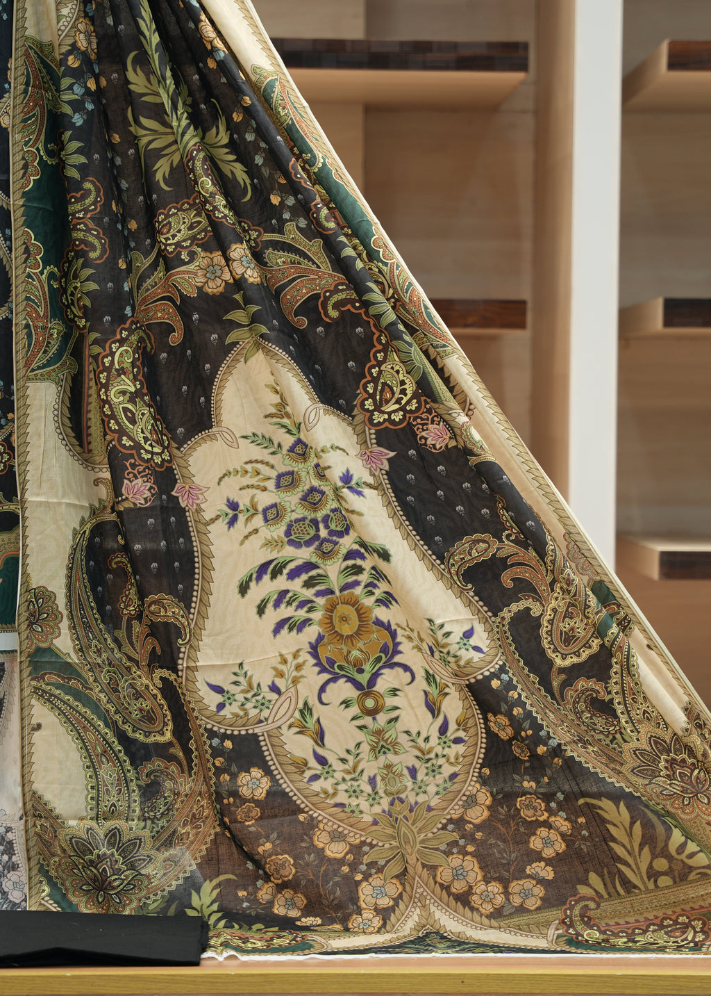 Decorative fabric with intricate patterns on a wooden surface