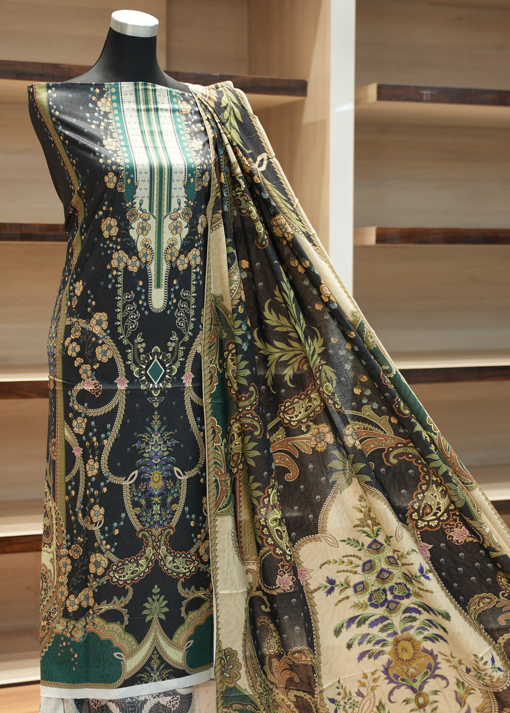 Mannequin wearing a patterned dress with a wooden shelf background