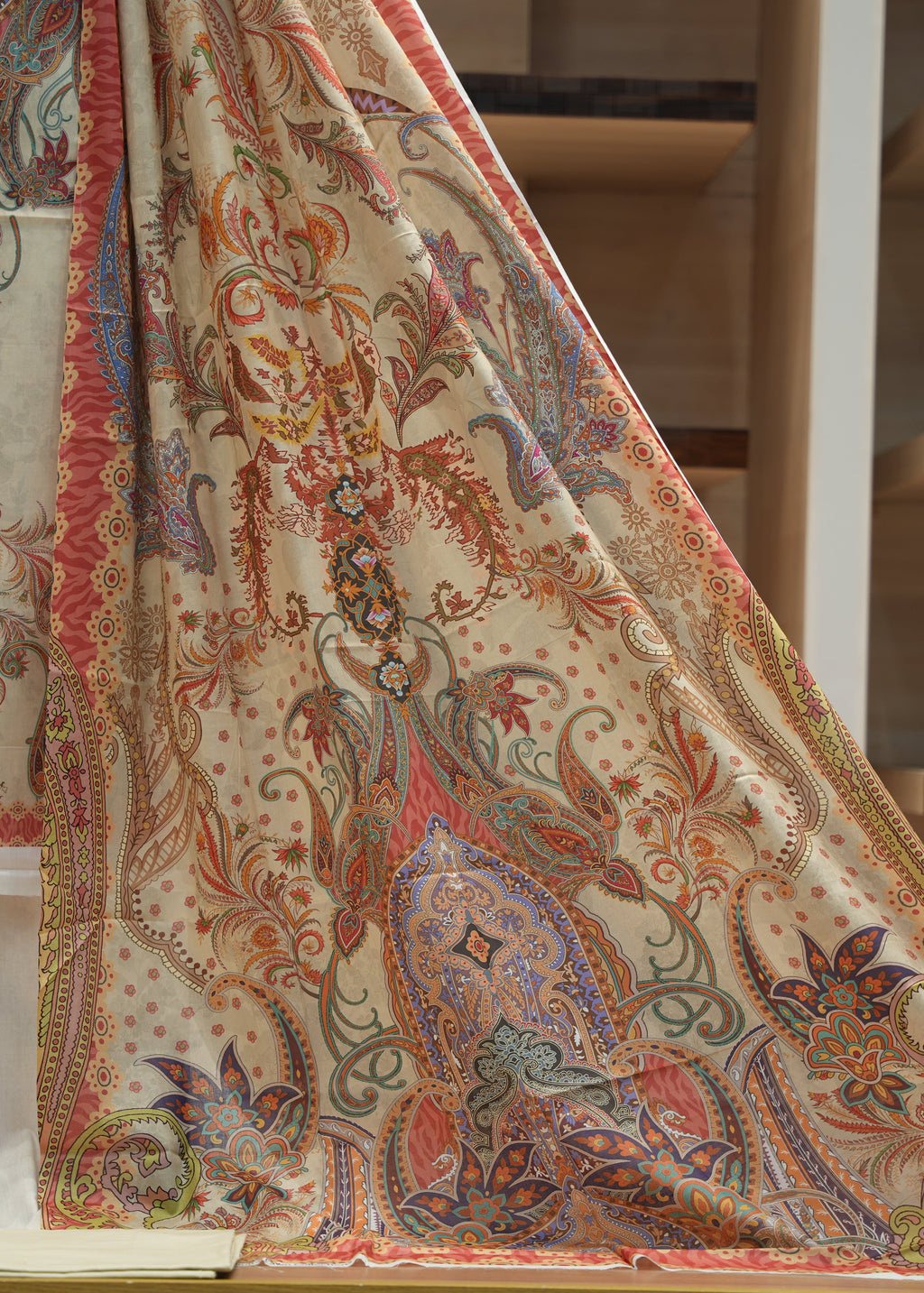 Close-up of a patterned fabric with intricate designs on a white background