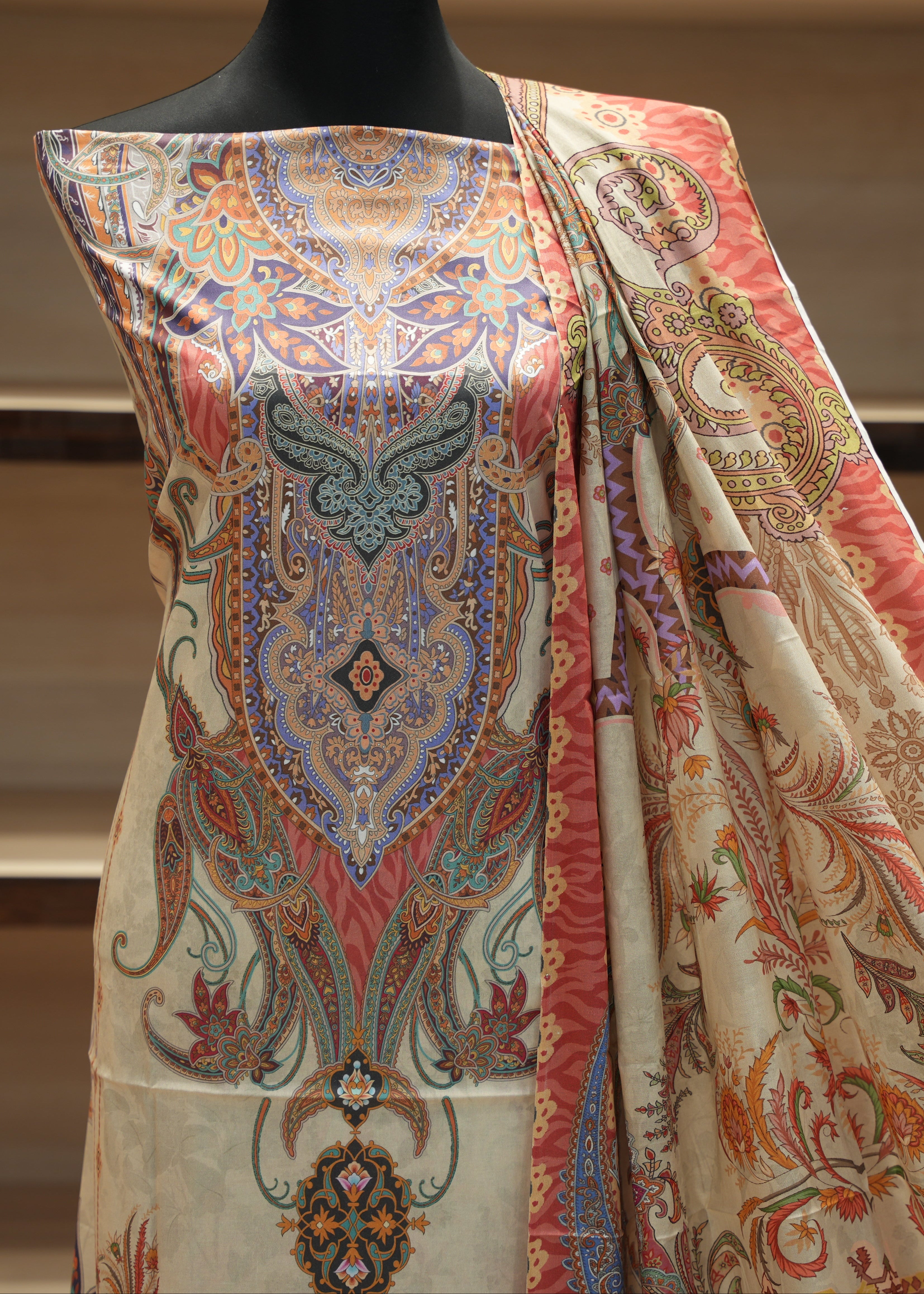 Decorative fabric with intricate patterns on a mannequin against a neutral background