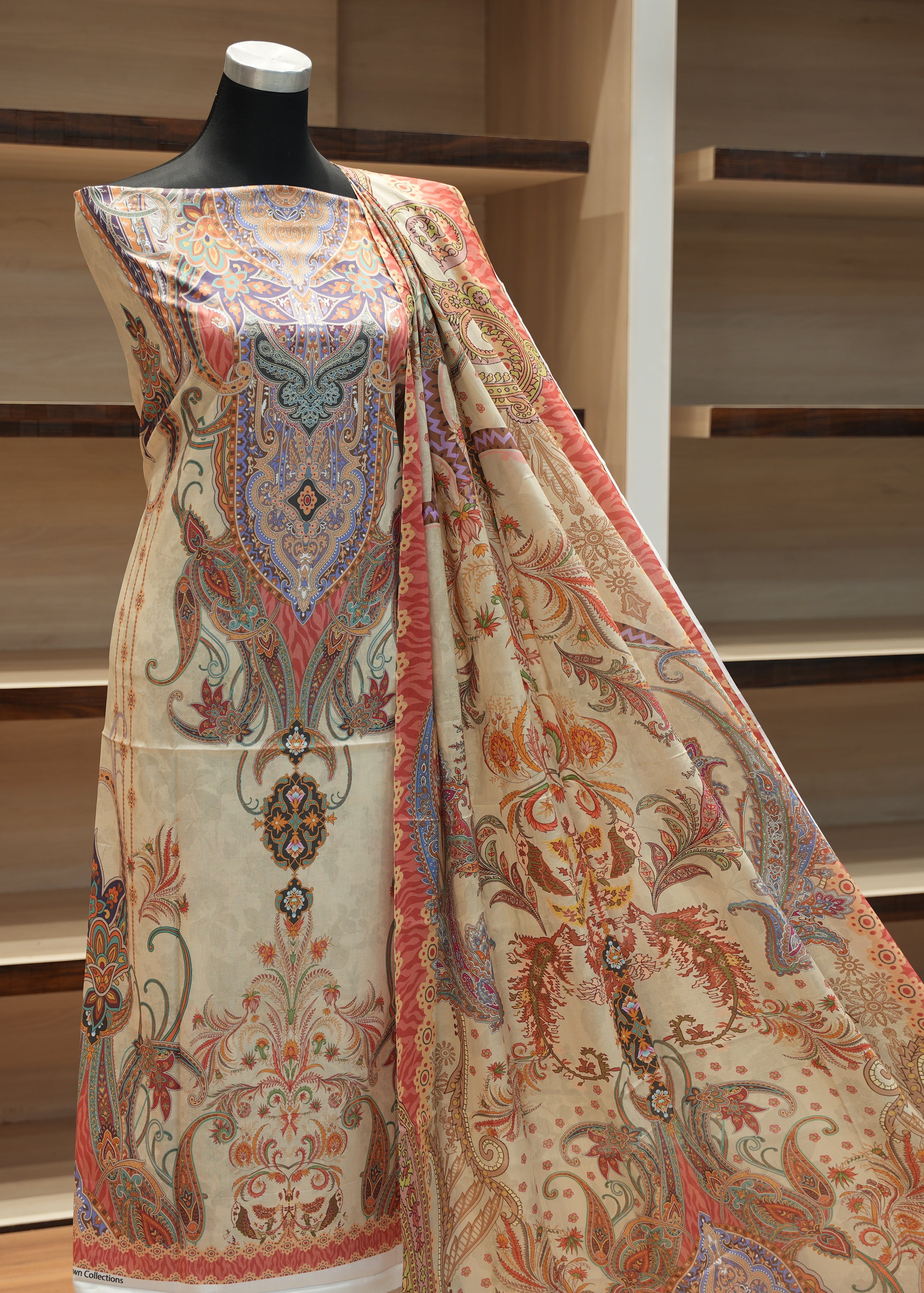 Mannequin wearing a patterned fabric with a wooden background