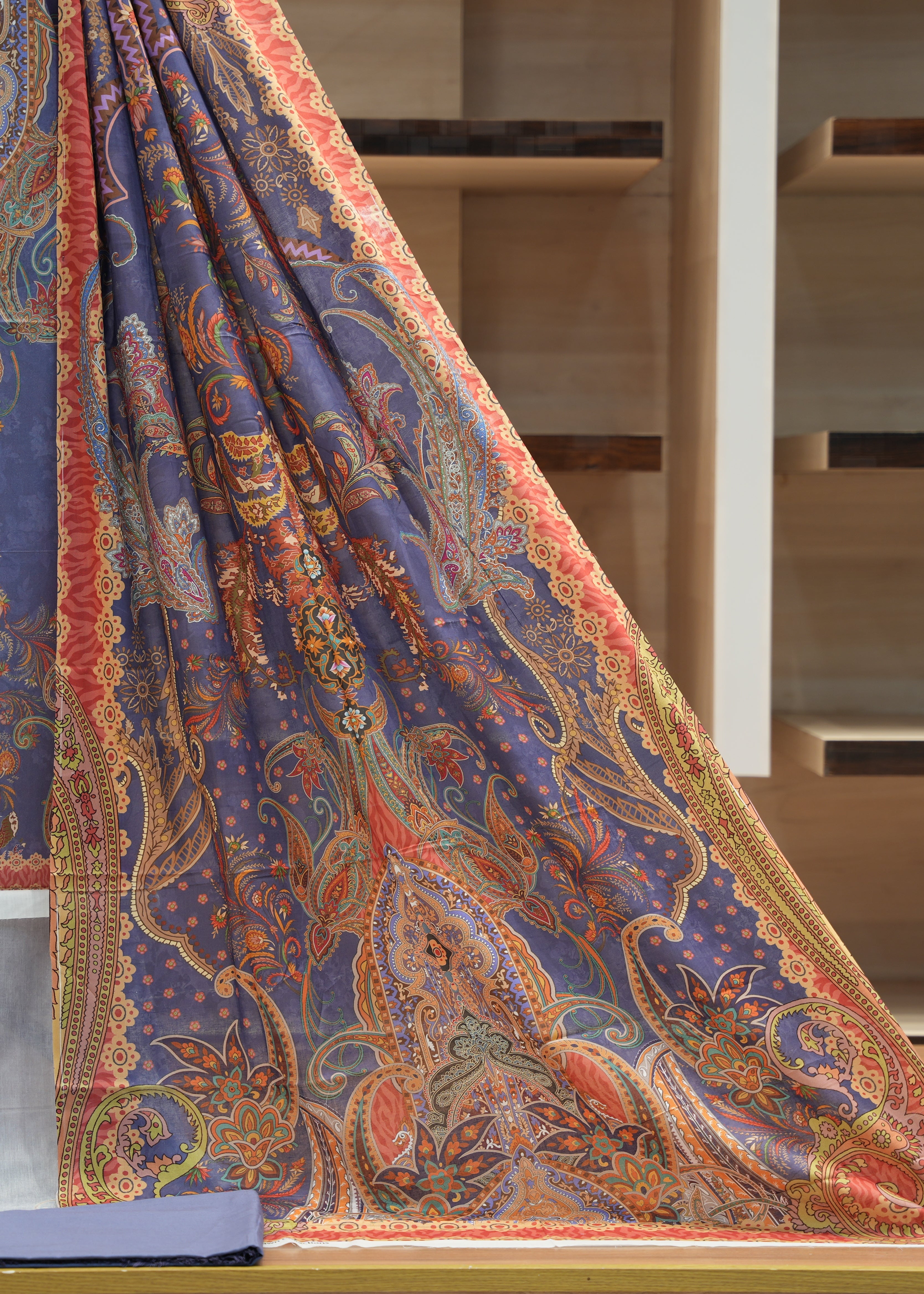 Colorful patterned fabric draped over a surface with a neutral background