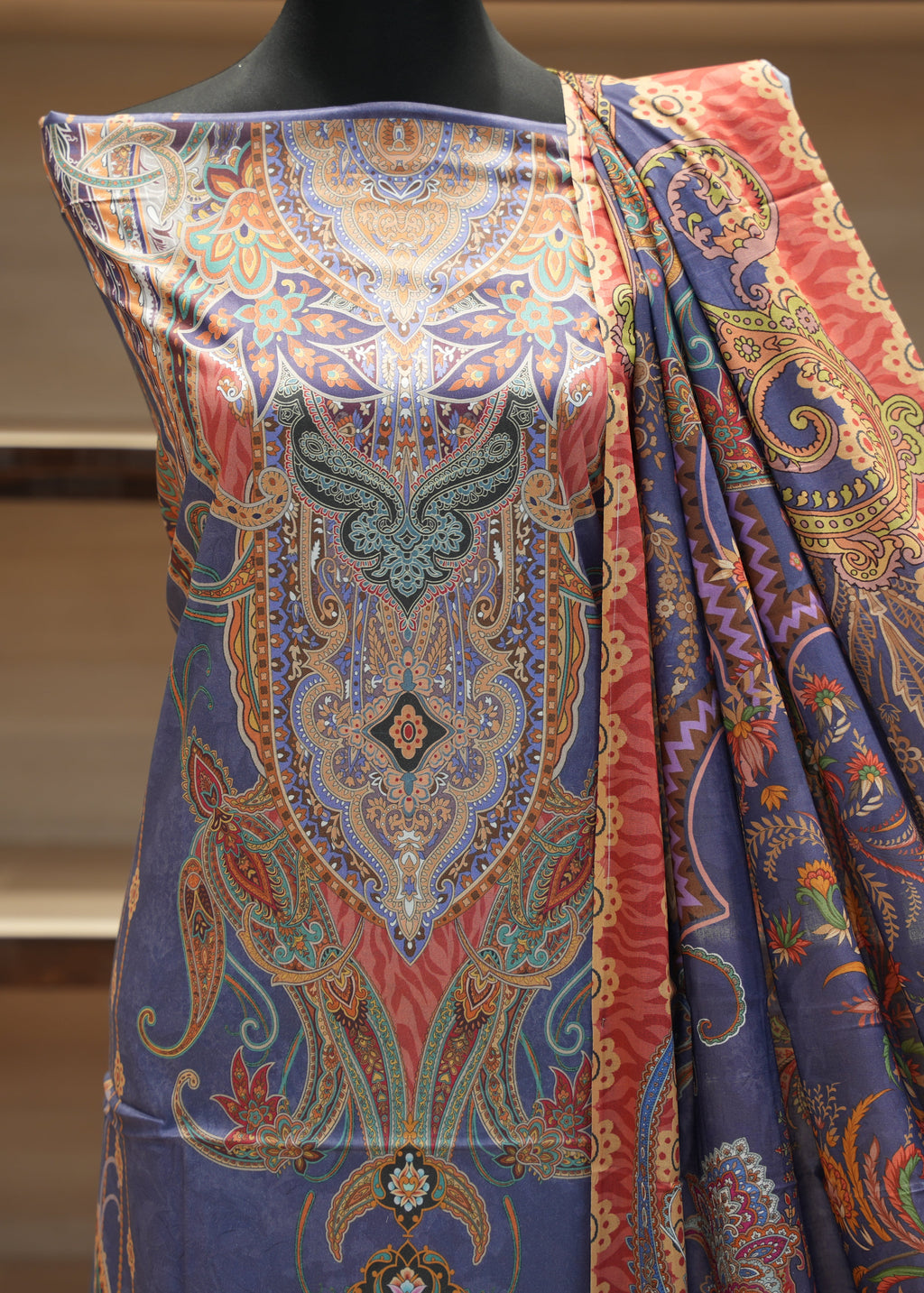 Colorful patterned fabric on a mannequin with a neutral background