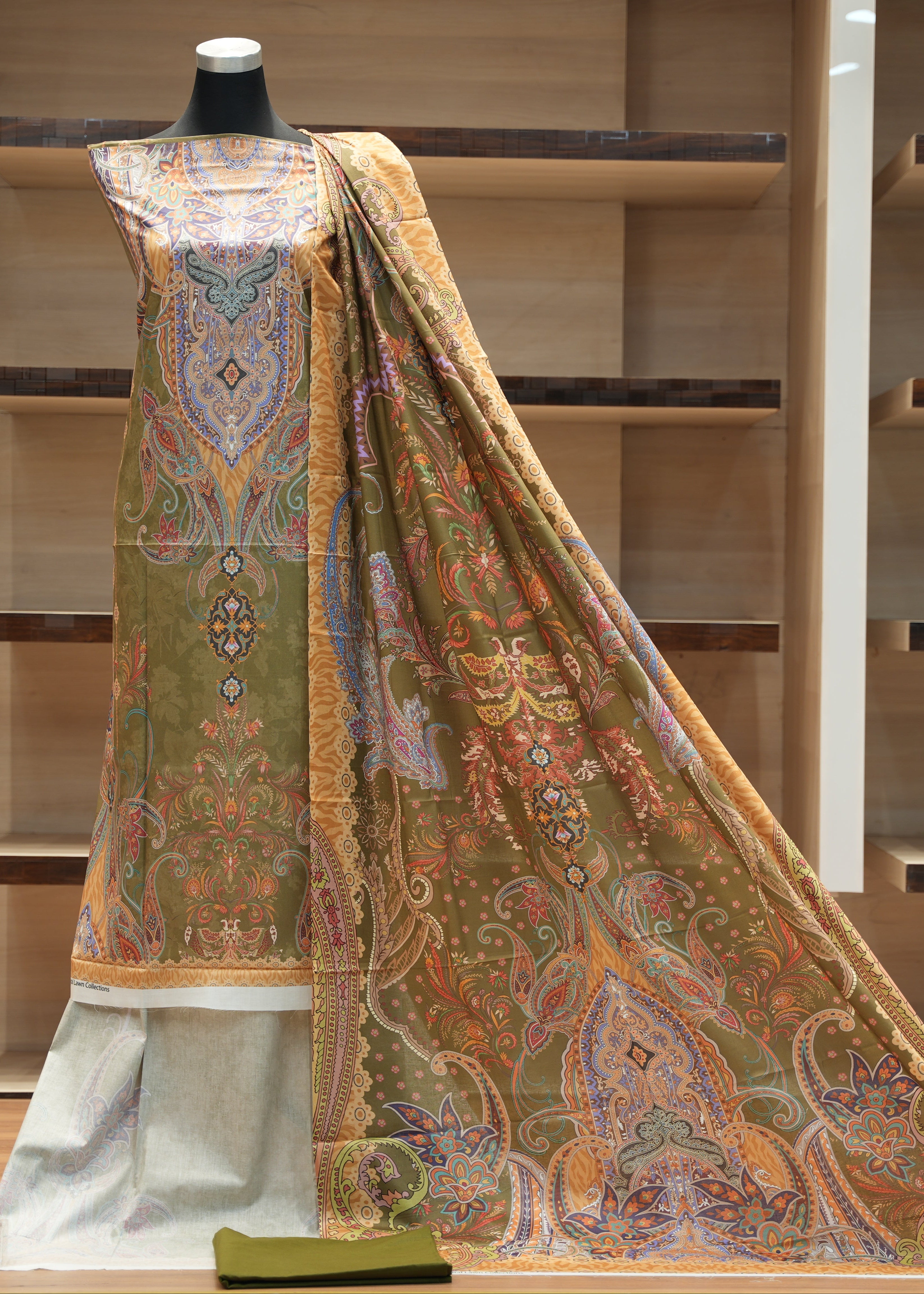 Traditional embroidered garment on a mannequin against a wooden background