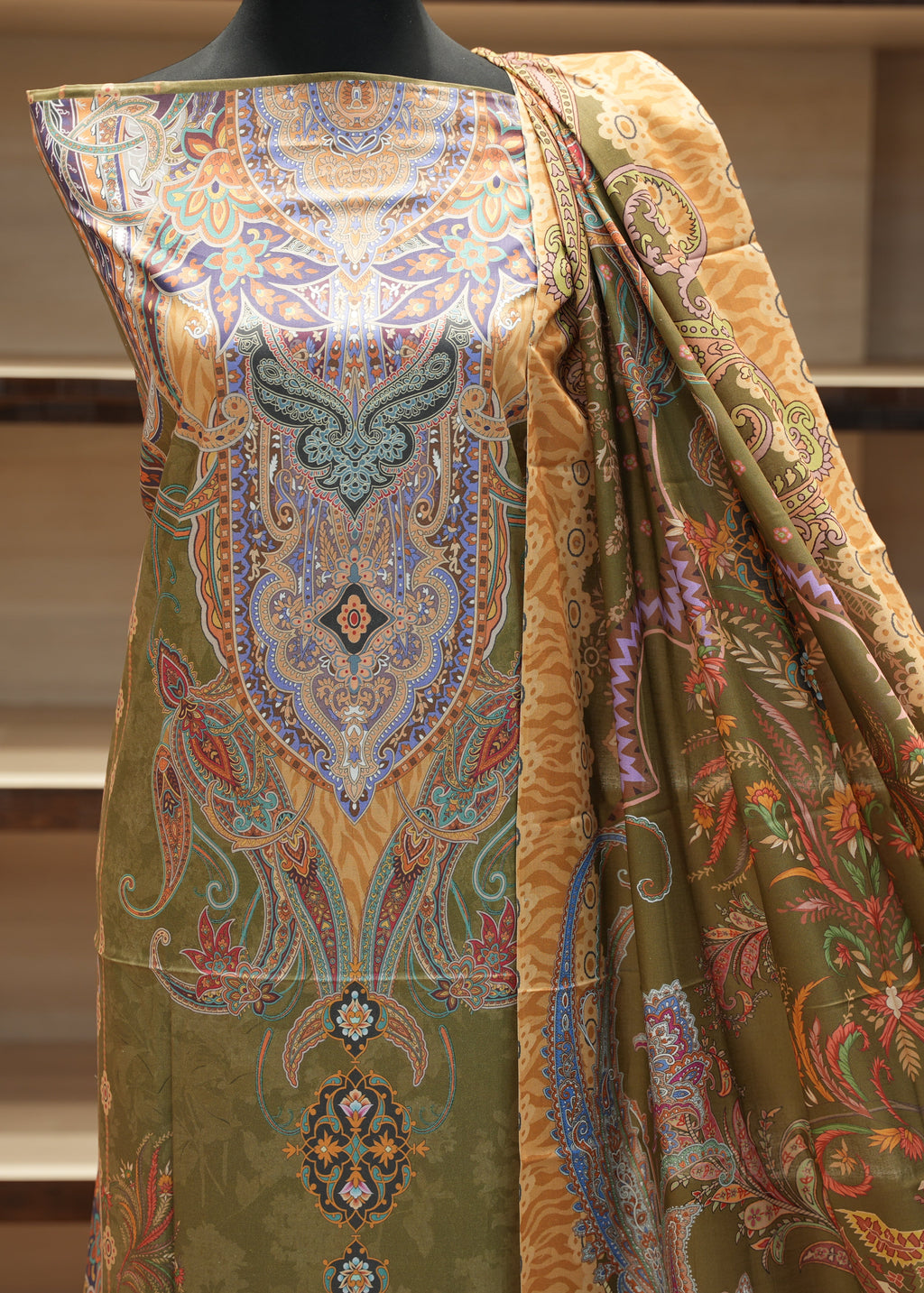 Colorful patterned fabric on a mannequin against a neutral background