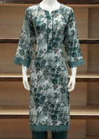 Floral patterned dress on a mannequin against a wooden shelf background