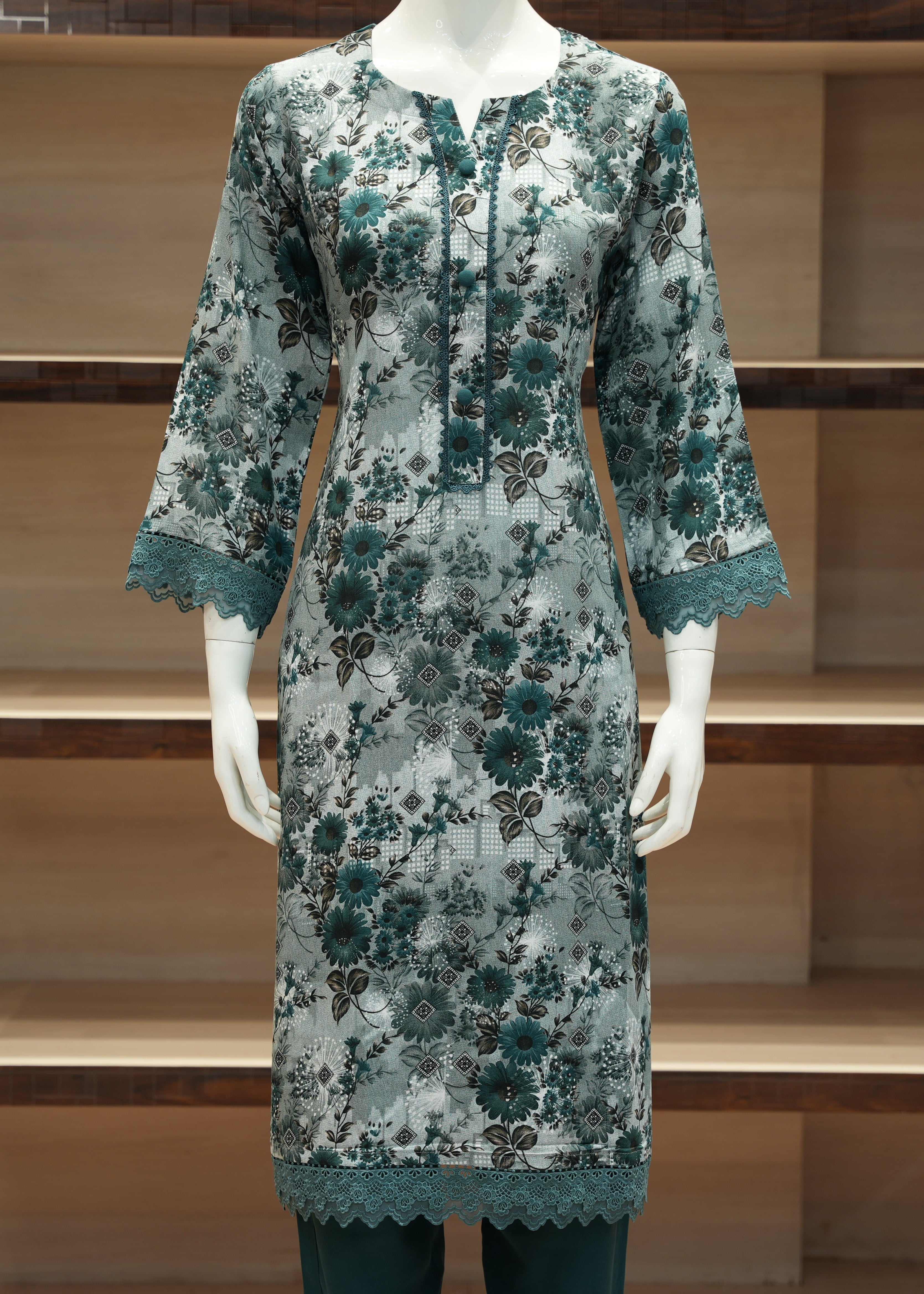 Floral patterned dress on a mannequin against a wooden shelf background