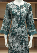 Floral dress on a mannequin against a wooden background
