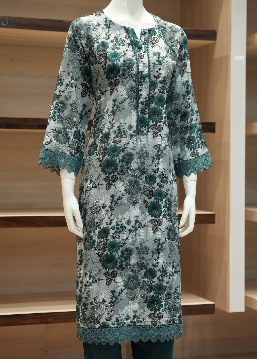 Floral dress on a mannequin against a wooden shelf background