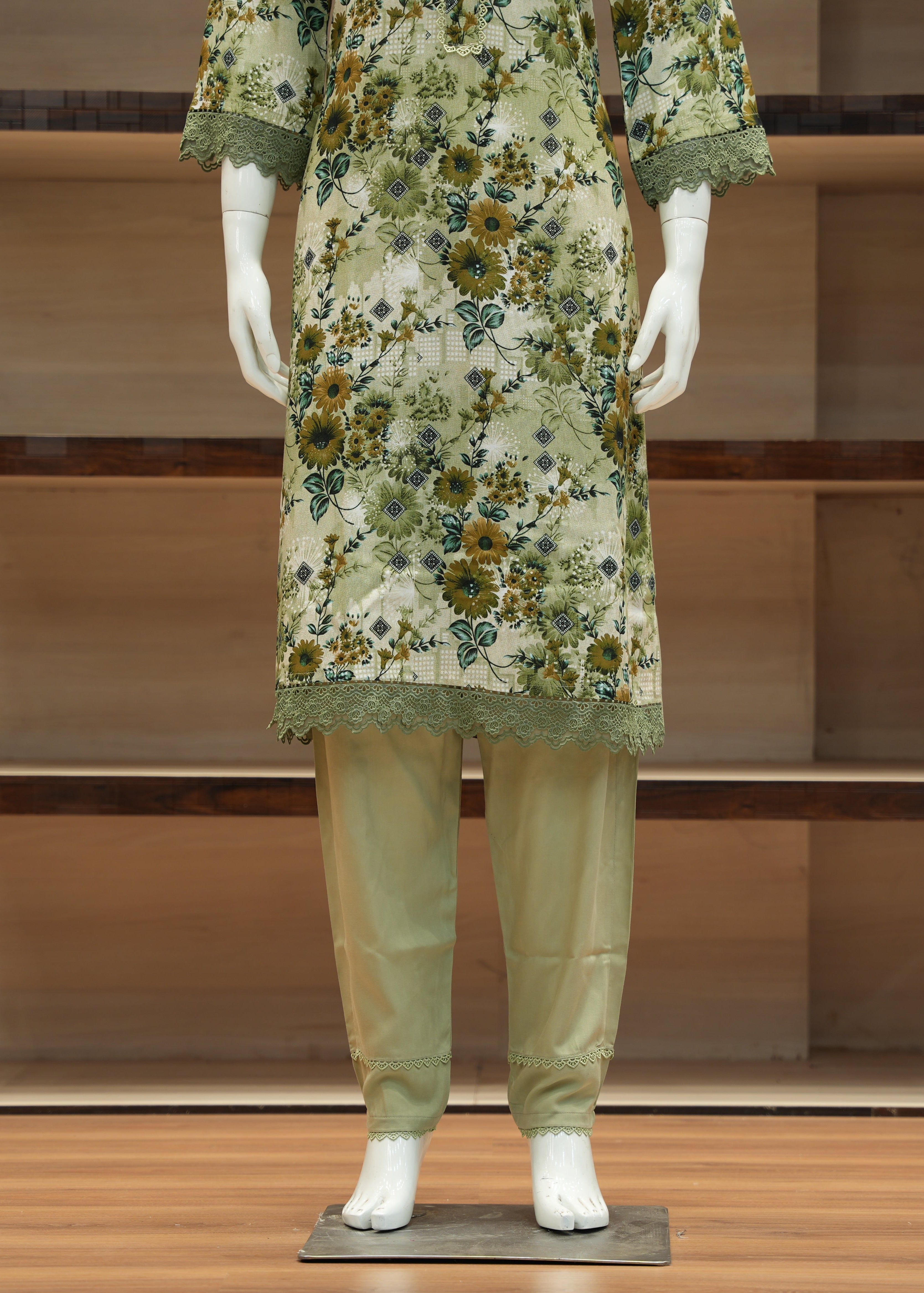 Mannequin wearing a floral dress and pants in a minimalistic setting