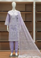 Mannequin wearing a lavender traditional outfit with a white embroidered dupatta against a wooden shelf background.
