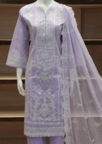 Lavender embroidered outfit with a dupatta on a mannequin against a wooden shelf background