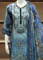 Mannequin wearing a blue and black patterned dress with a matching shawl.