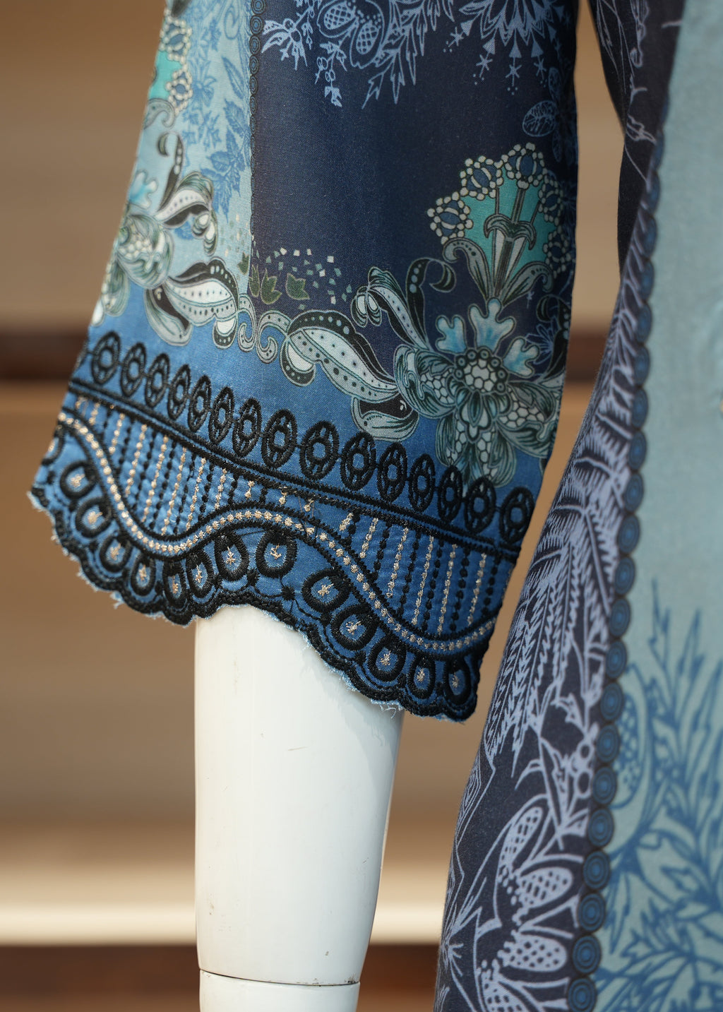 Close-up of a blue and white patterned garment on a mannequin.