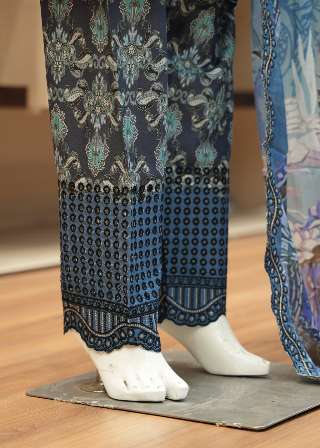 Traditional Japanese kimono with intricate patterns on a wooden floor.