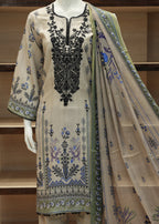 Beige embroidered outfit with a matching dupatta on a mannequin against a wooden shelf background.